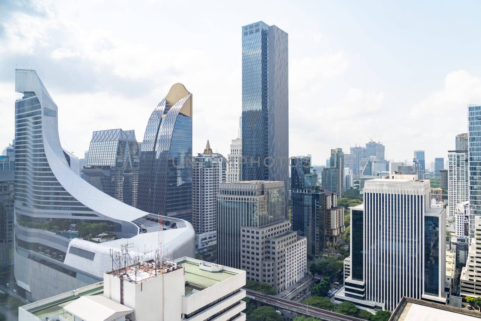 Closeup image of Bangkok cityscape. Modern cityscape surrounded with architectural building with day light and blue sky. Side view. Business background. Day light. Ornamented.