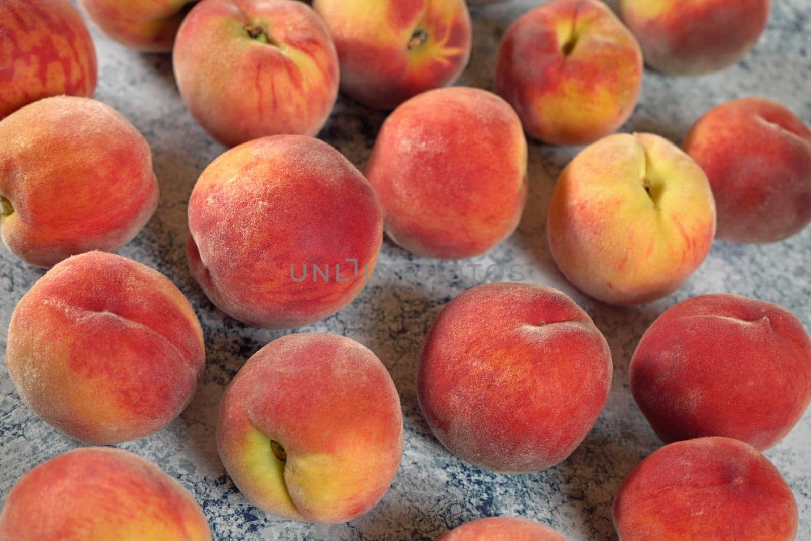 Group of apricots on blue marble like board, closeup photo