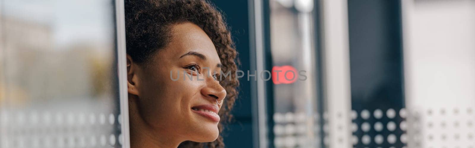 Close up of female freelancer is using mobile phone standing in coworking during break time by Yaroslav_astakhov