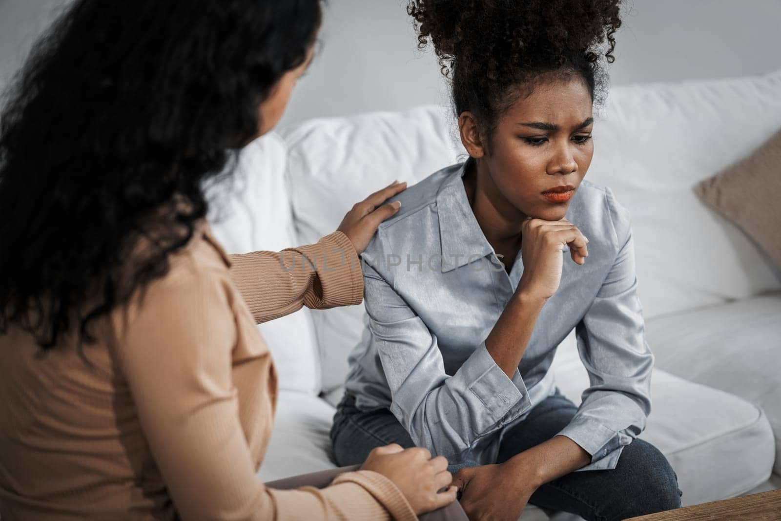Sad PTSD woman patient in crucial therapy for mental health with psychologist, depression or grief after life failure. Frustrated trauma young woman talking to a psychologist about emotion in clinic