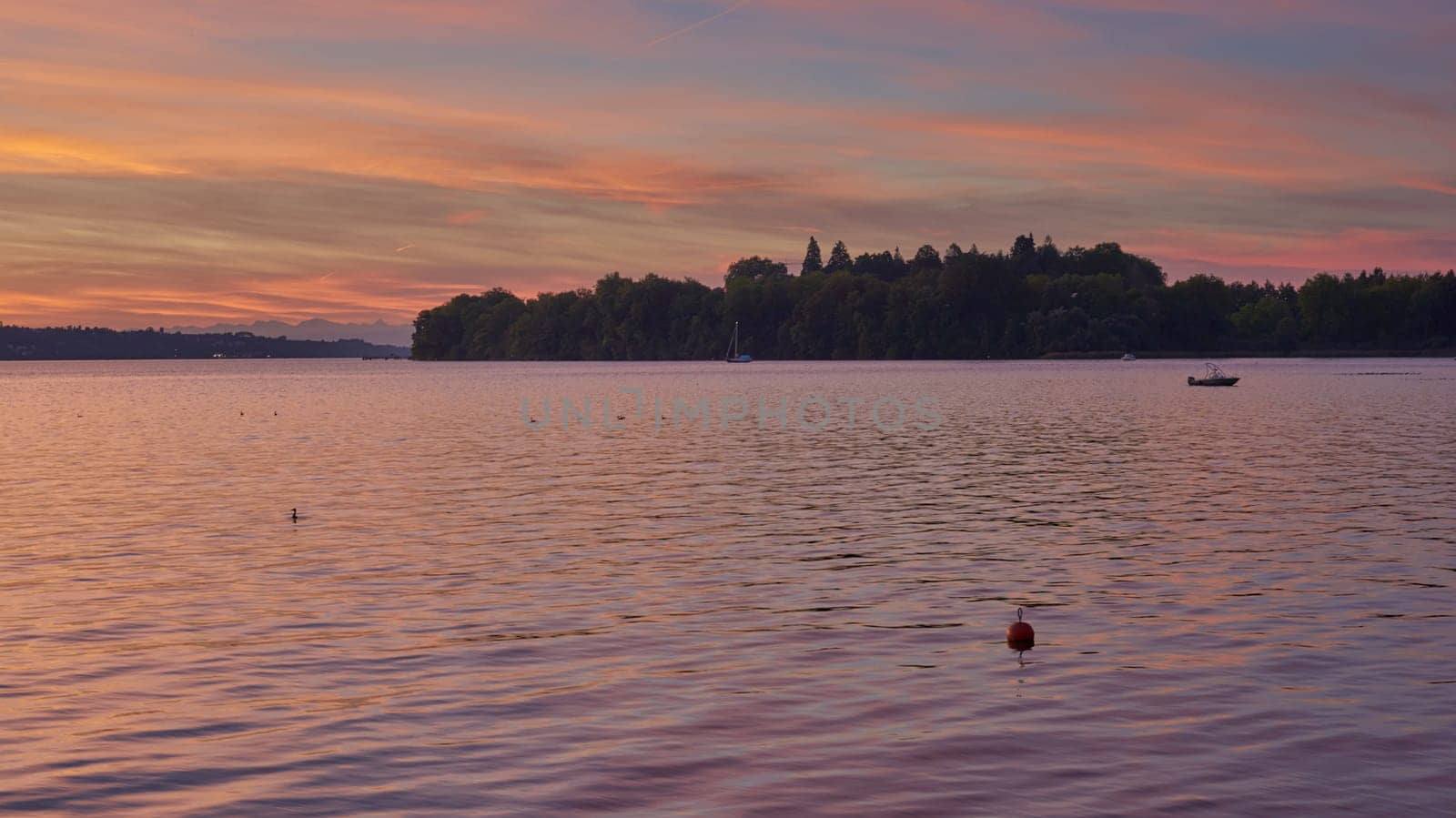 Bodensee Lake Sunrise Panorama. Morning Sunlight Over Tranquil Waters. by Andrii_Ko