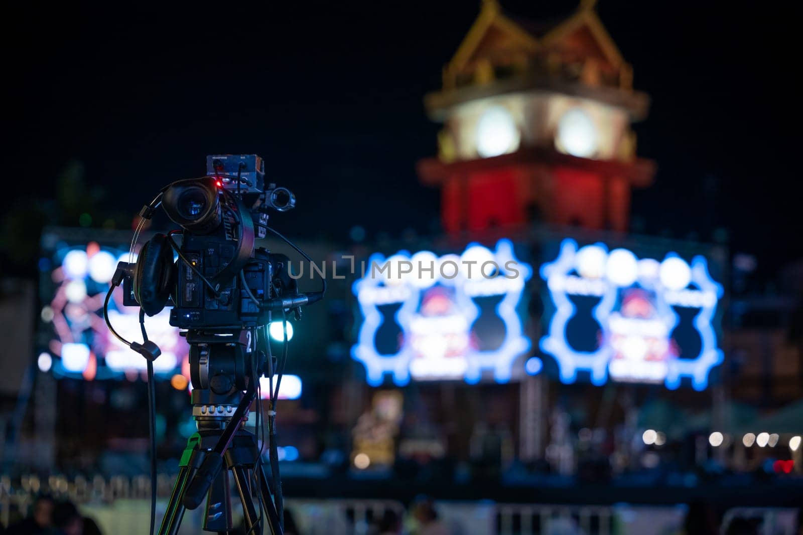 Video production team covers live event on stage. Professional crew utilizes multimedia for movie-like streaming. Expertise in cinematography and live broadcasting, Video equipment