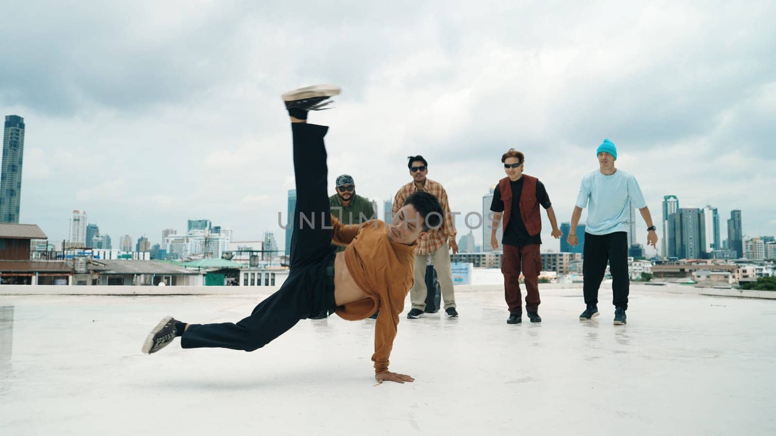 Profession break dancer practice B-boy dance with friends at roof top. Endeavor. by biancoblue