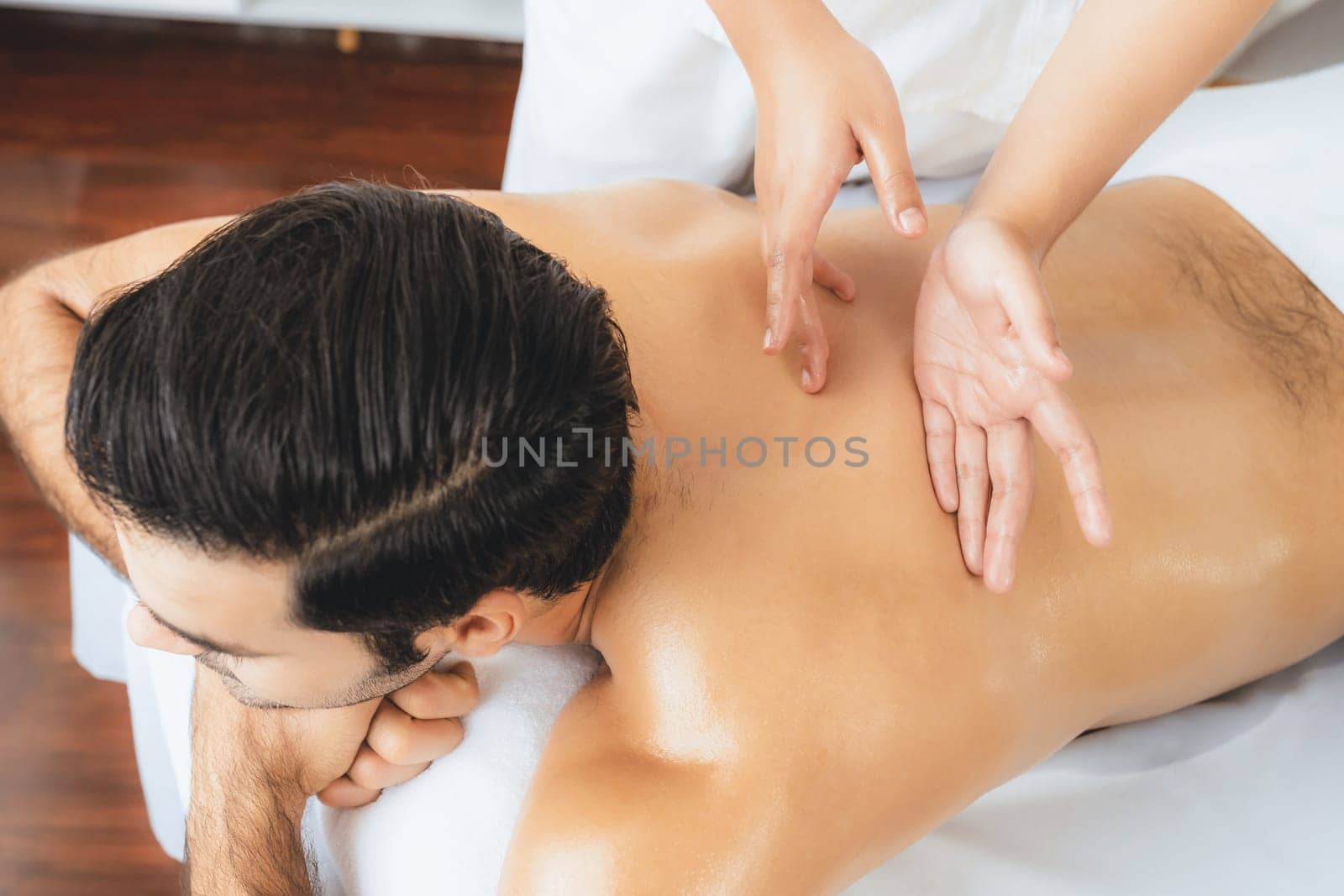 Caucasian man customer enjoying relaxing anti-stress massage. Quiescent by biancoblue