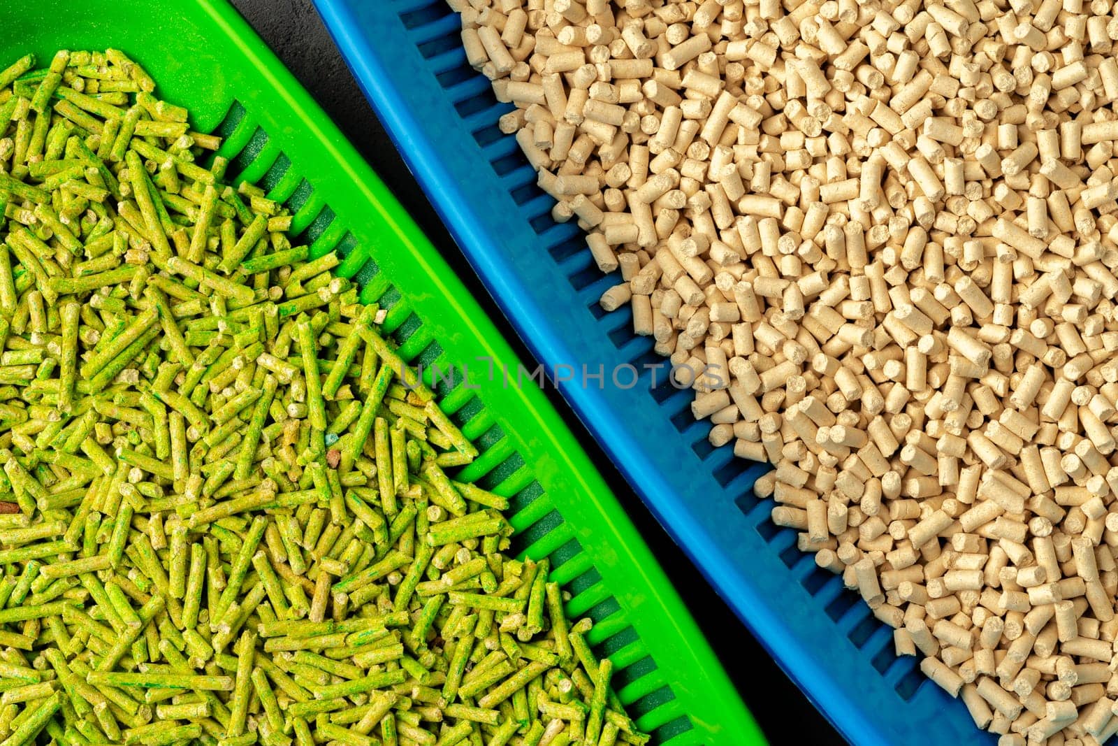 Pet litter tray with wooden filler on gray background close up