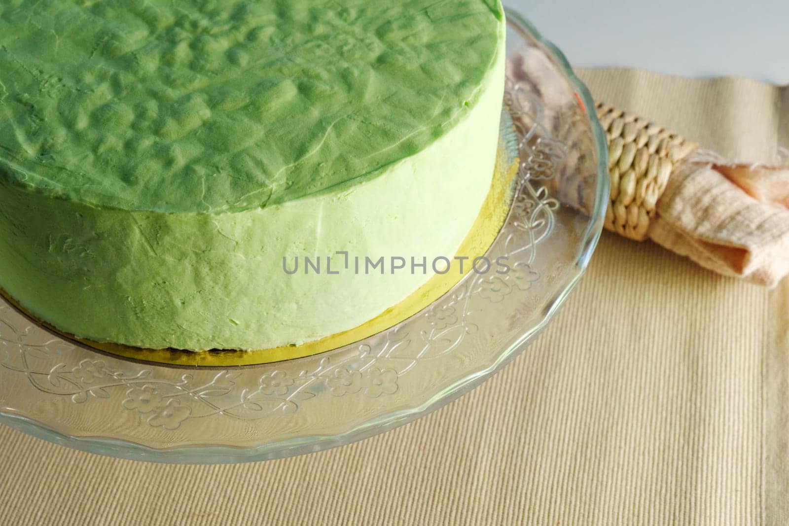 Enigmatic Emerald: A Vibrant Green Cake Gracefully Adorns a Delicate Glass Plate by darksoul72