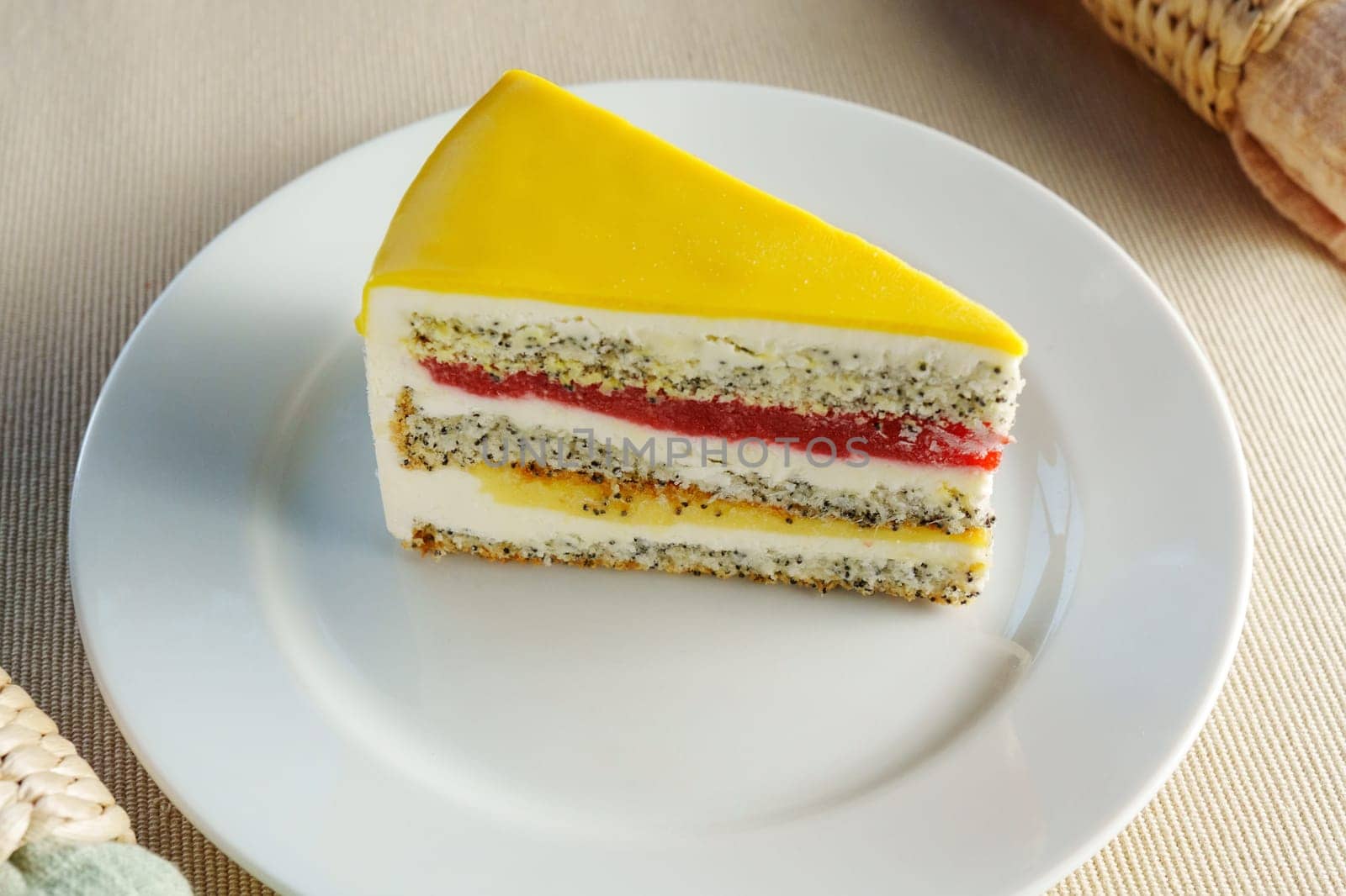 Indulge in the delectable sight of a scrumptious slice of cake gracefully placed on a pristine white plate.