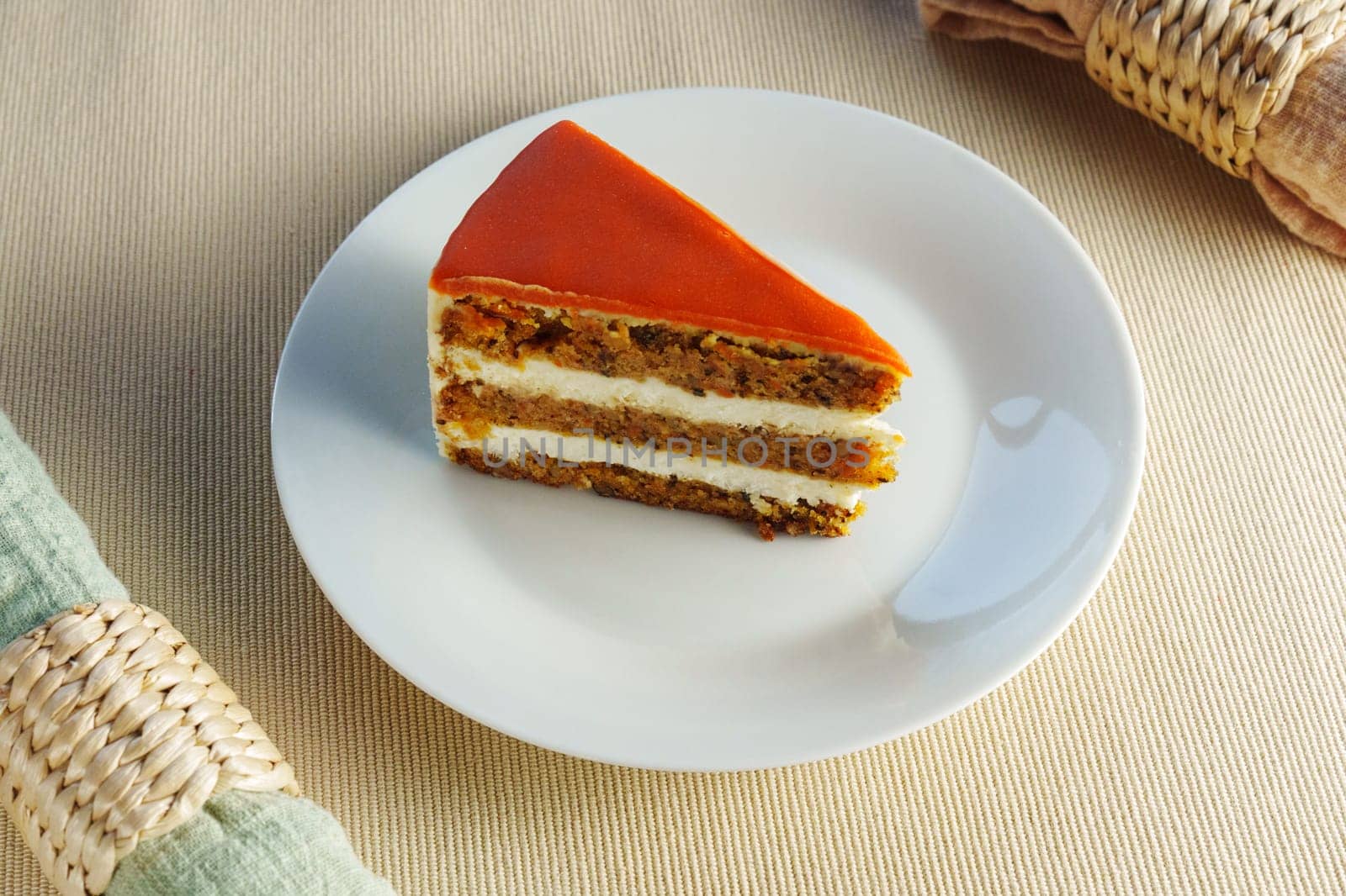 Featuring a slice of moist and flavorful carrot cake beautifully presented on a pristine white plate. by darksoul72