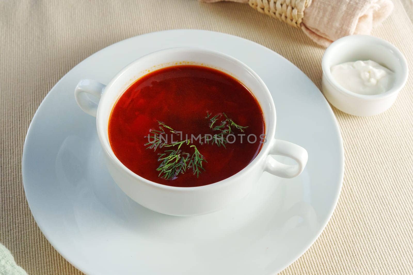 Serenity in a Bowl: Captivating Creamy Tomato Bisque Served With a Gleaming Silver Spoon