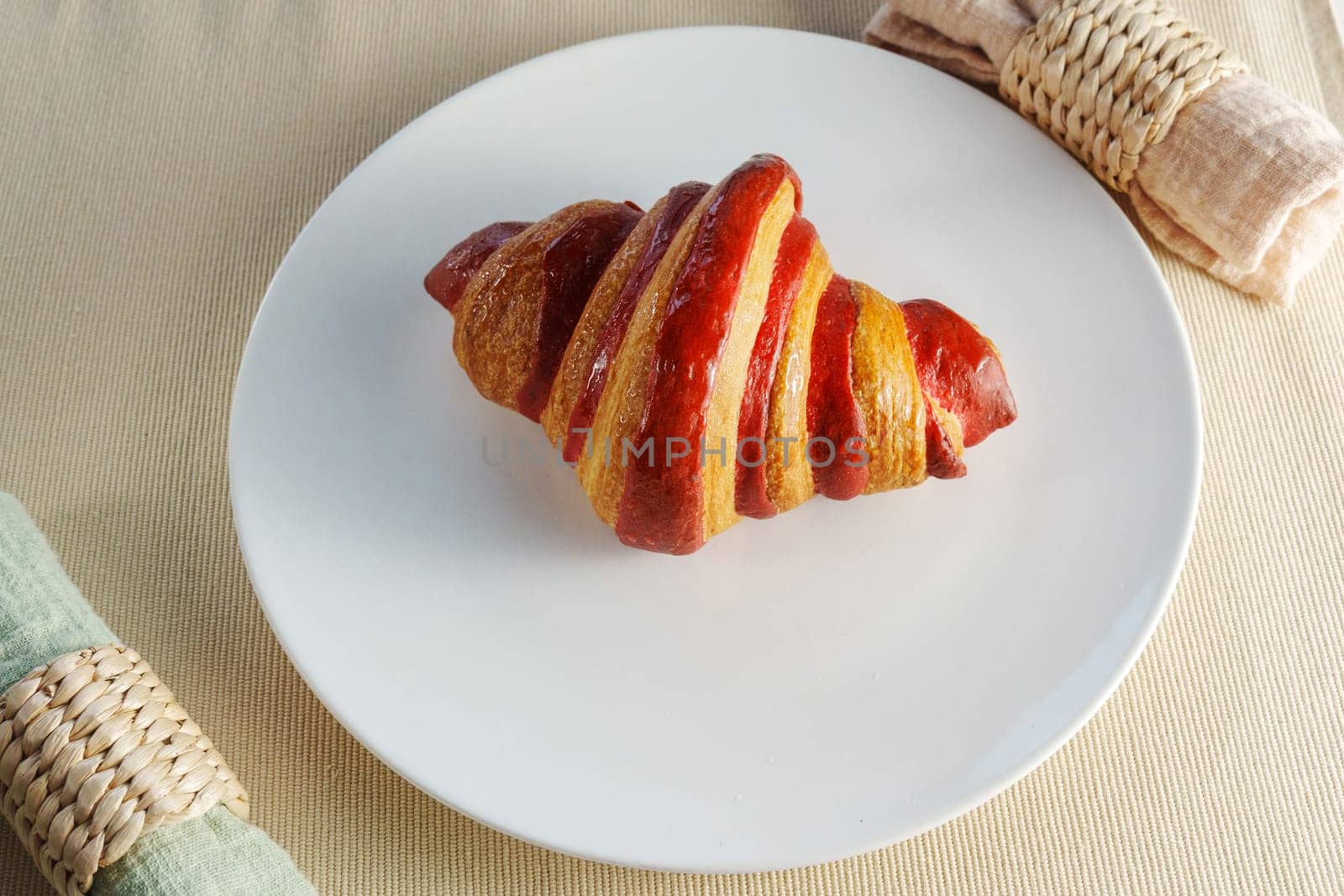 Croissant vibrant piece of fruit, a succulent crimson strawberry, creating an ethereal and evocative composition.
