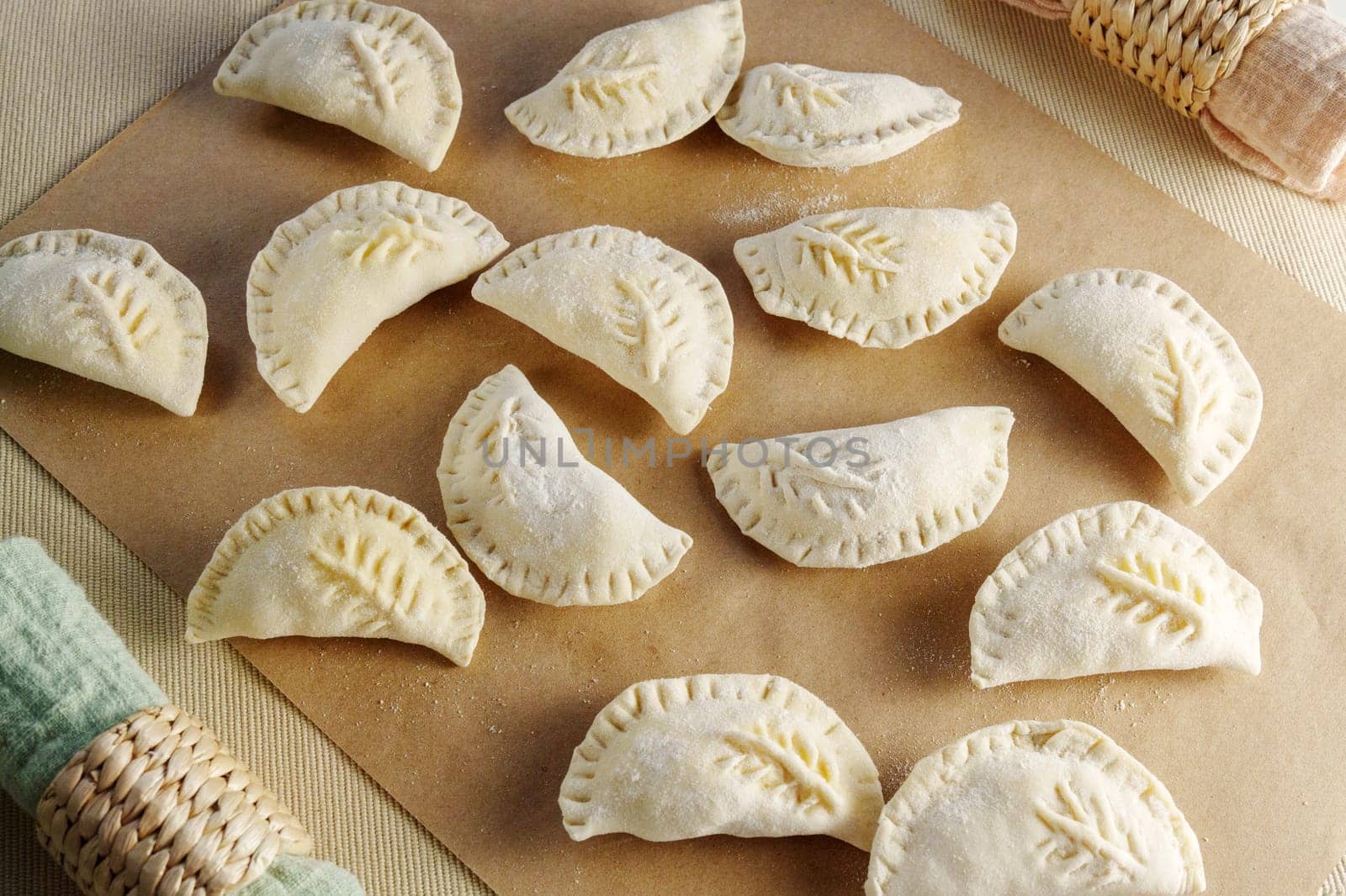 Variety of beautifully crafted dumplings artfully assembled on a wooden cutting board by darksoul72