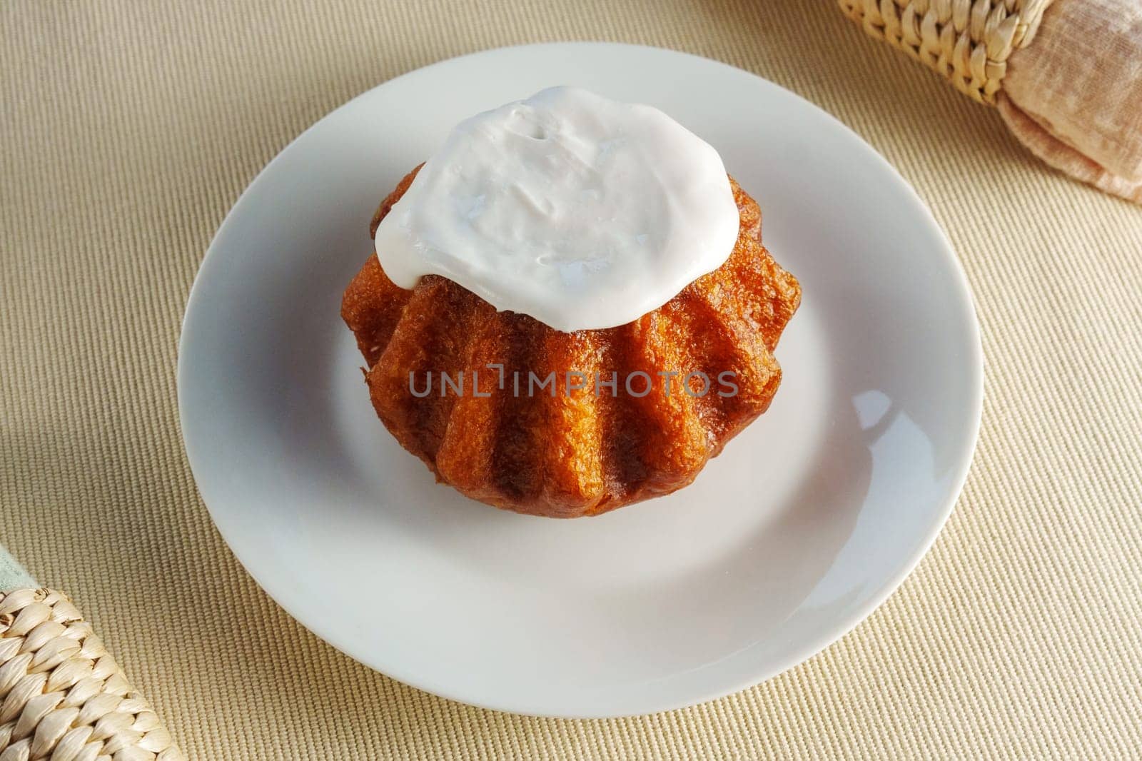 A tantalizing cupcake sits on a delicate plate, adorned with a fluffy mountain of whipped cream topping. by darksoul72