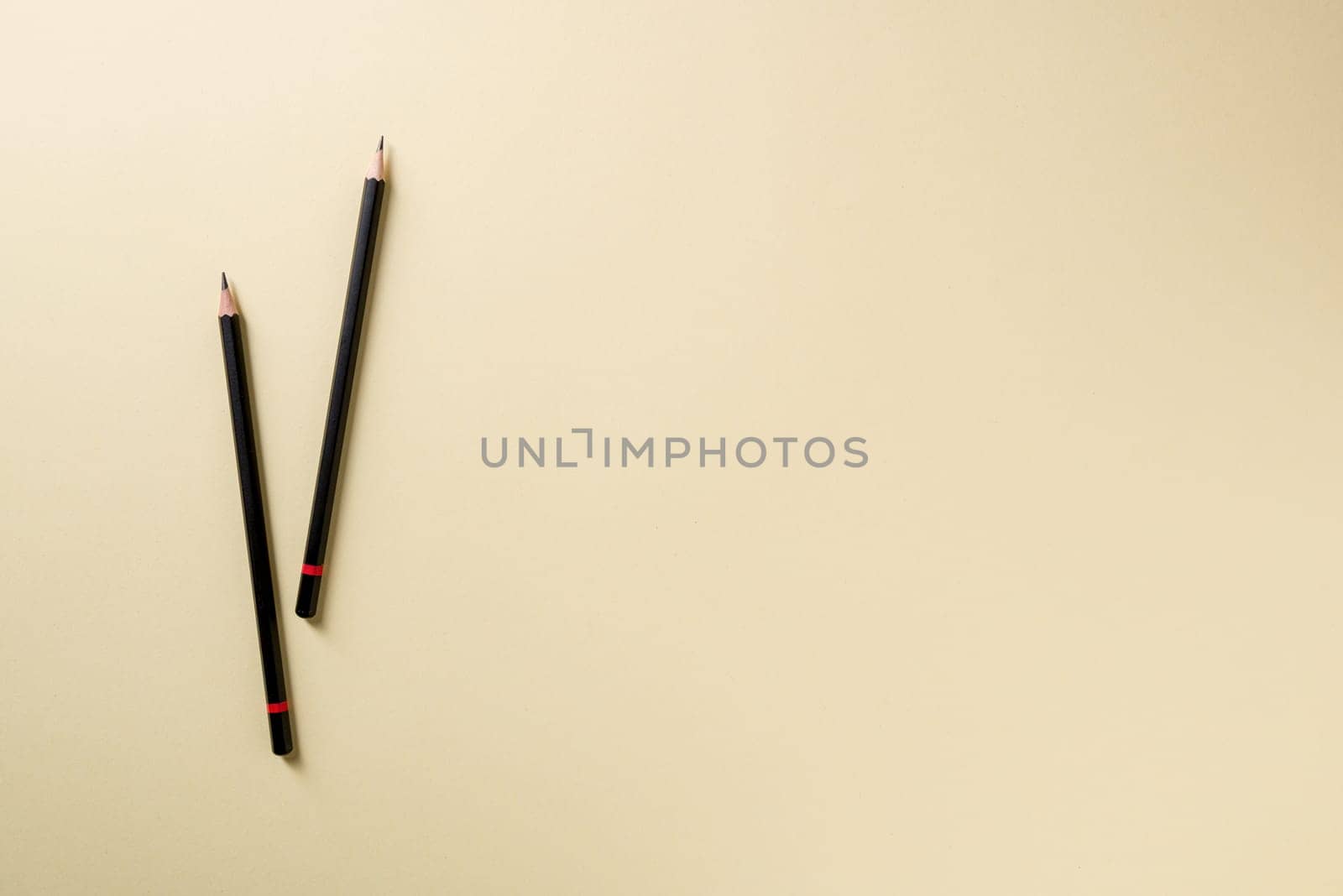 Pencil with black paint and a red stripe on a yellow background by Sonat