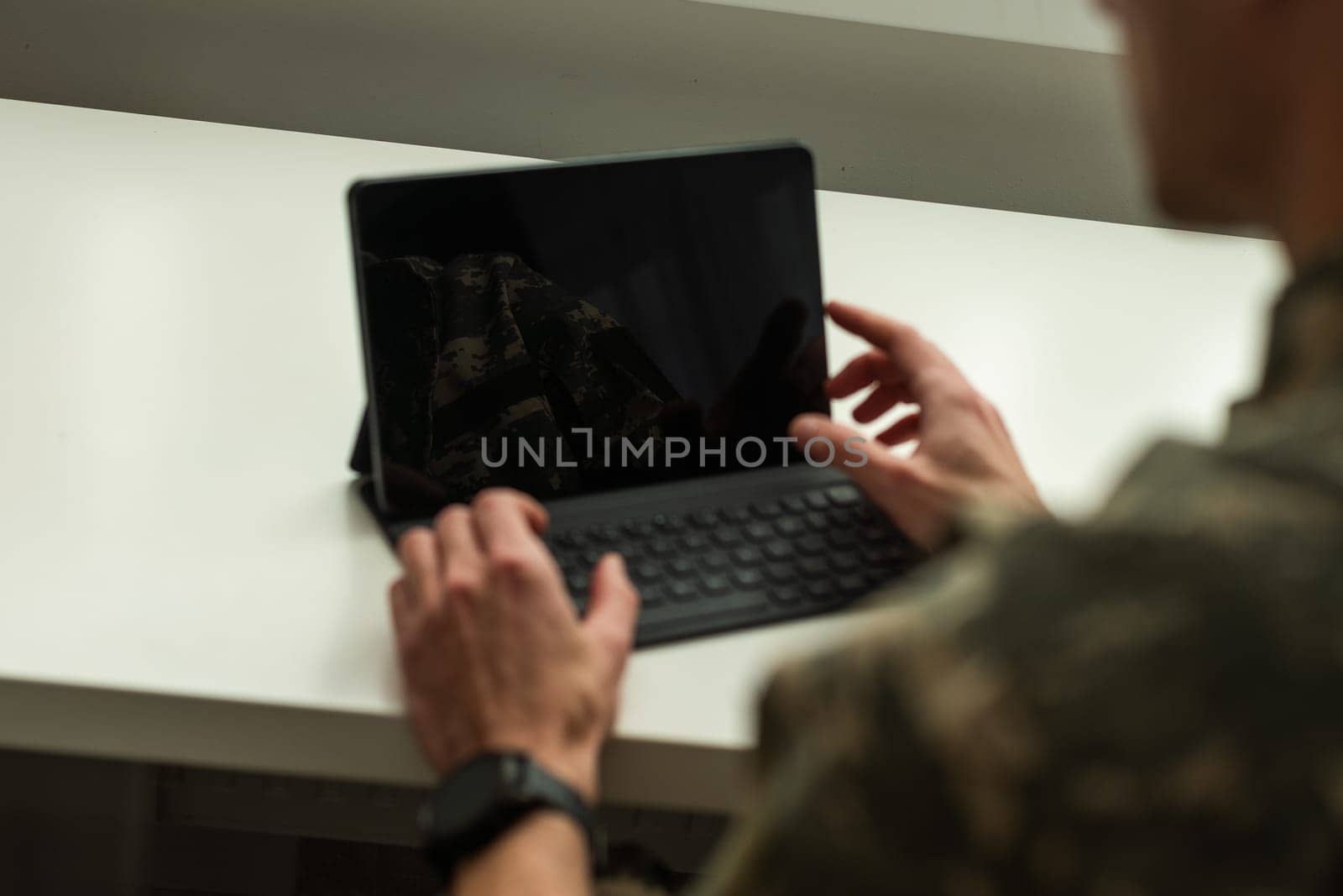 Happy soldier using laptop. Military service. High quality photo