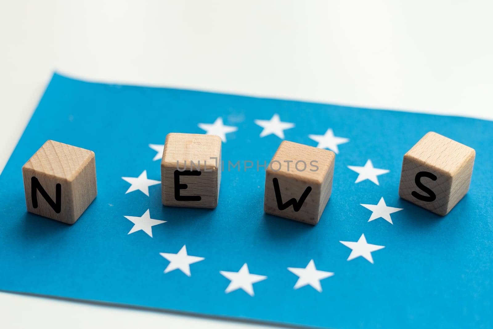 dice the word news and the flag of the European Union. High quality photo