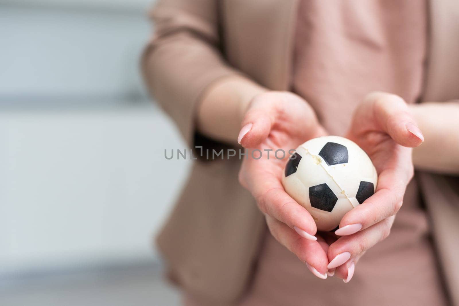 Woman hand with football on white background. High quality photo