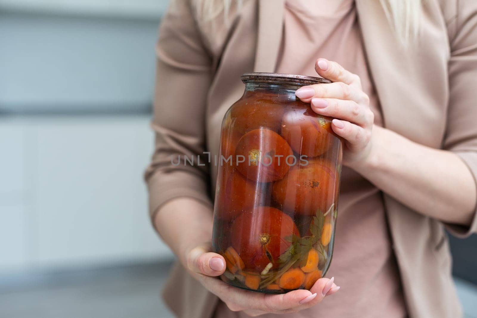 hands tomatoes in a jar on a white background isolation. High quality photo