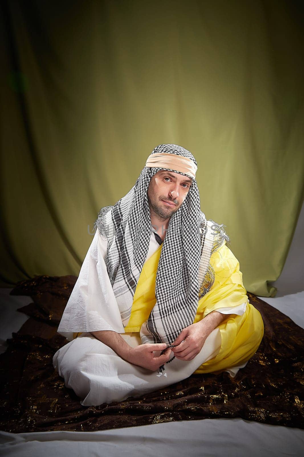 An imposing man in stylized eastern attire, Sheikh or Sultan in Israel, Palestine, and Iran. Photoshoot with a male model