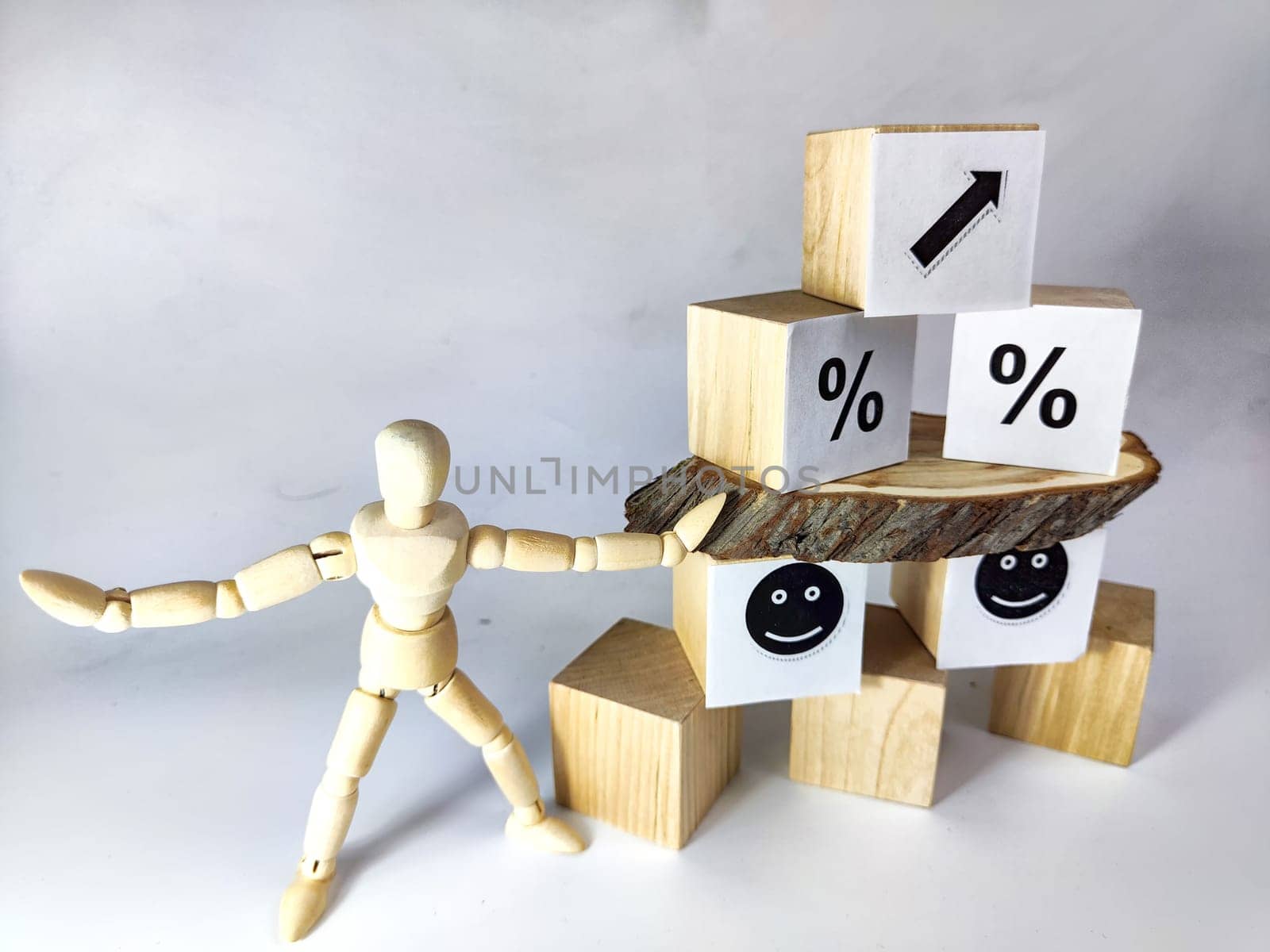 Wooden cubes in a column and row with white signs with a smiley sign, an arrow, a percentage. The concept of positivism. Positive thinking leads to the achievement of results and profits