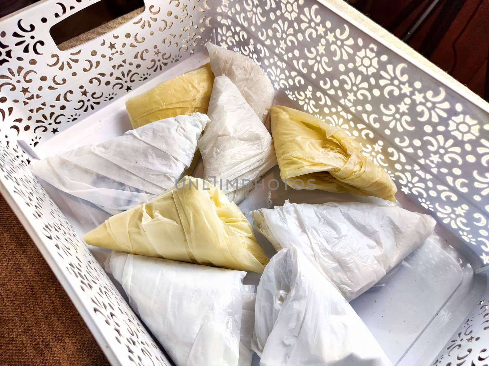 Plastic bag folded into triangle for storage. Ways of storing and laying at home