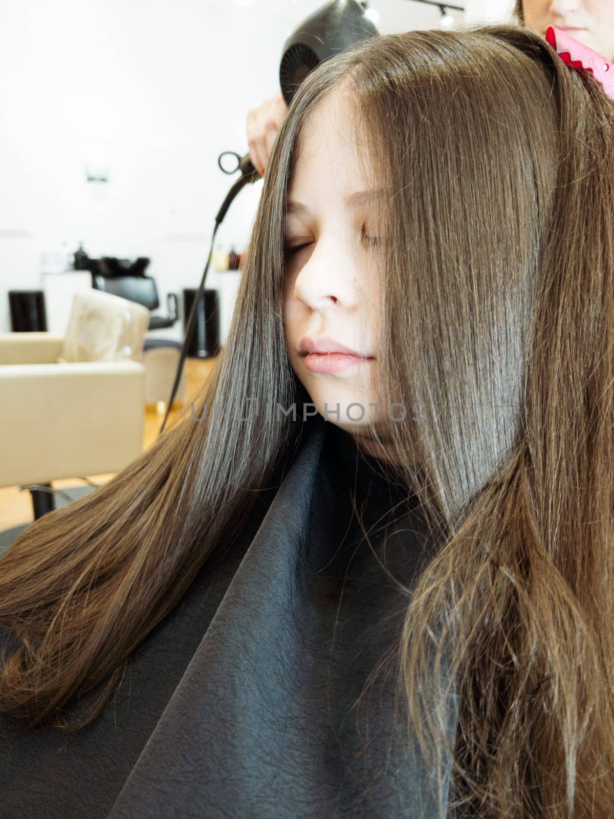 Final Touches with a Hair Dryer on a Little Girl's Fresh Cut by arinahabich