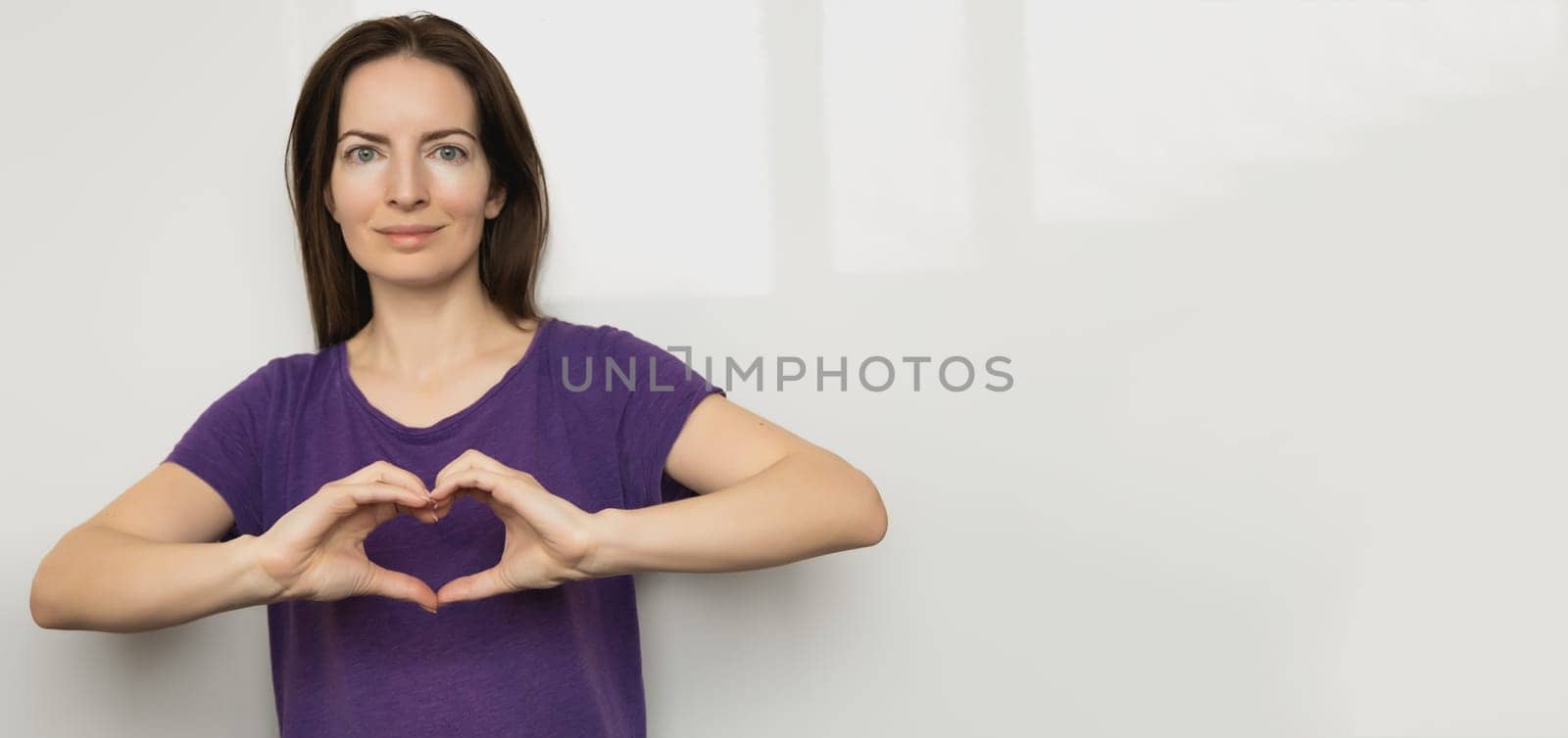 Inspire inclusion. Zoomers symbolize love. Woman finger heart dressed purple t-shirt. Hand showing heart. International Women's Day 2024 banner, inspireInclusion. by Ri6ka
