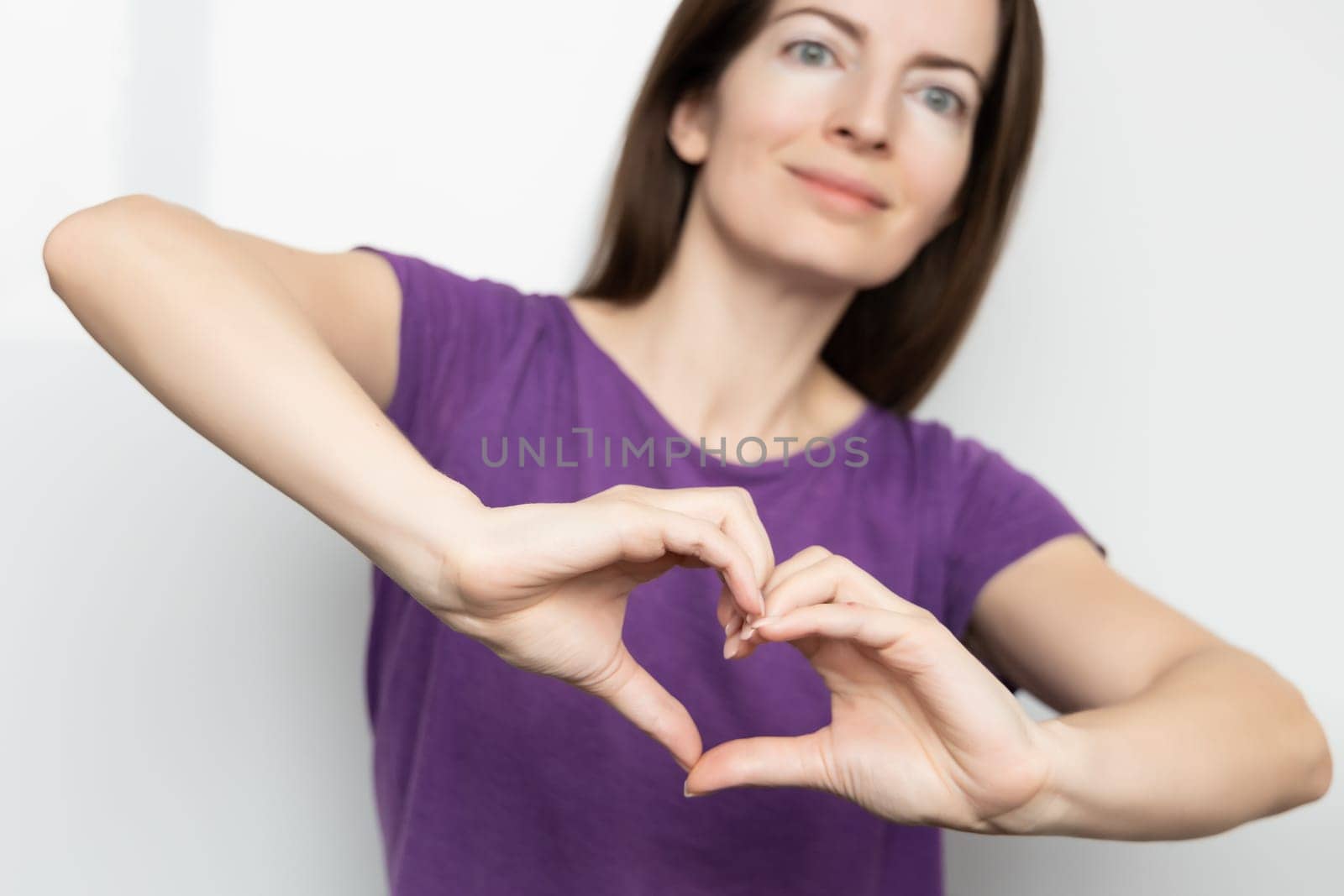 Inspire inclusion. Zoomers symbolize love. Woman finger heart dressed purple t-shirt. Hand showing heart. International Women's Day 2024 banner, InspireInclusion