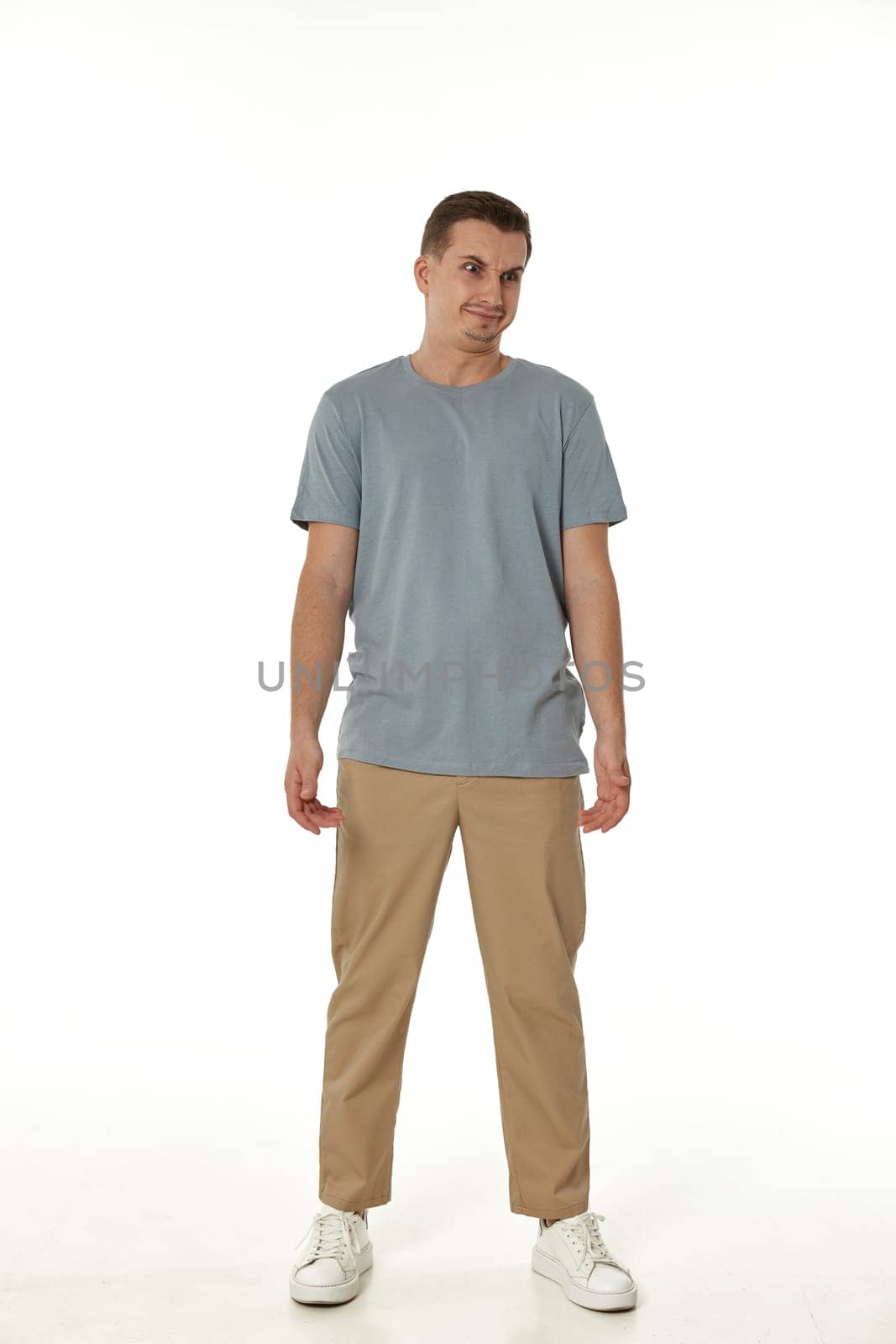 annoyed angry man standing on white studio background