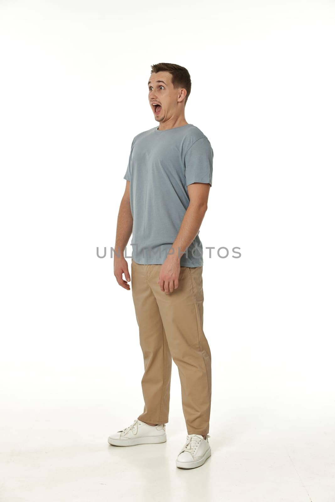 surprised guy looking at camera on white studio background