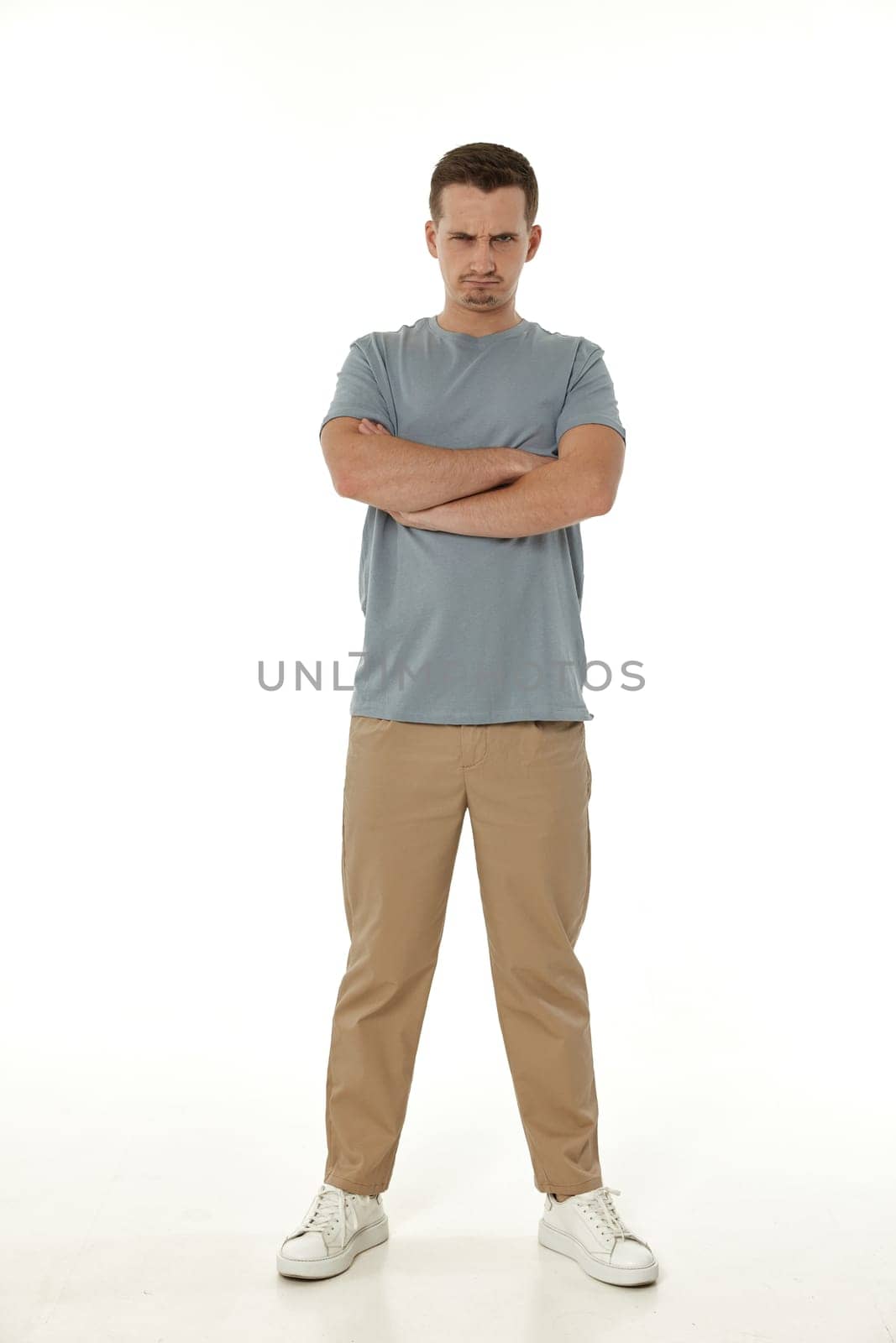 offended frustrated young man on white background. sadness