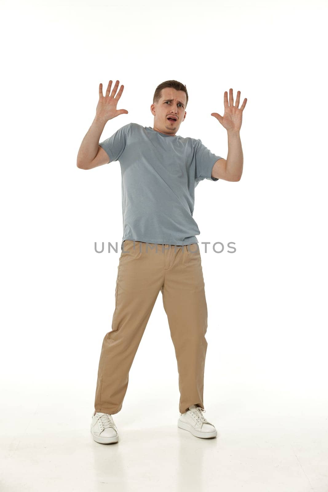 scared guy looking at camera on white studio background