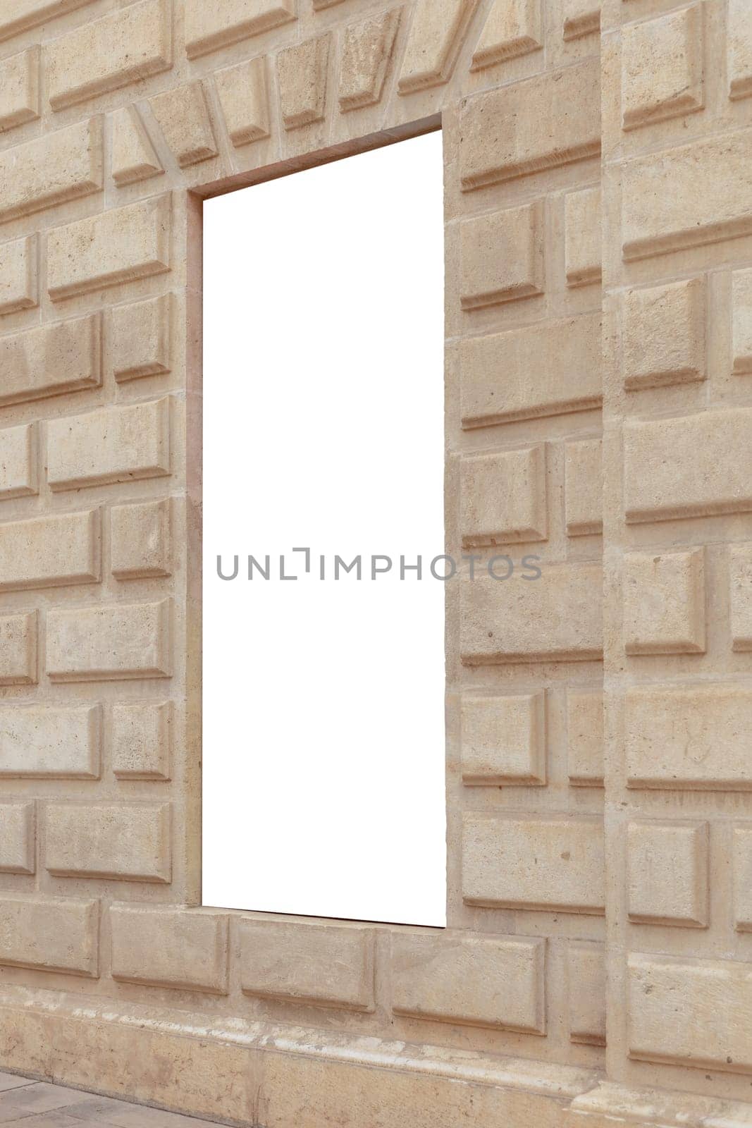 Vertical blank billboard set in a textured sandstone wall, perfect for advertisements or custom content in a historical or urban setting. Empty, copy space for your picture, text. Billboard mock up