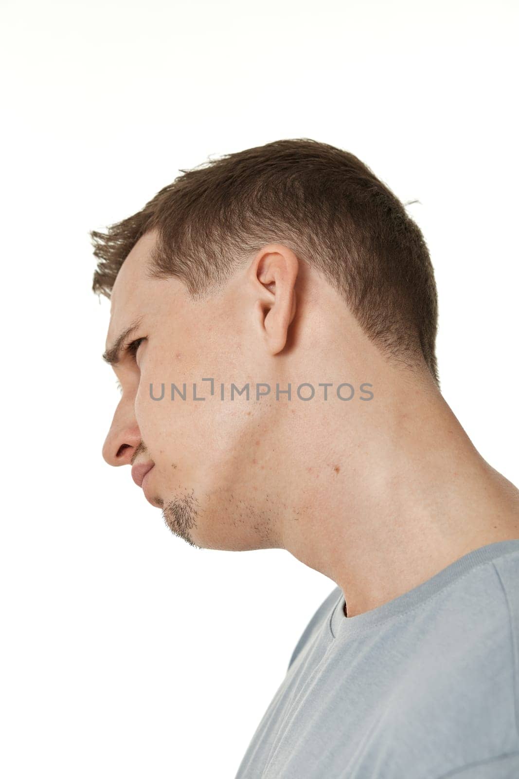 offended frustrated young man on white background. sadness