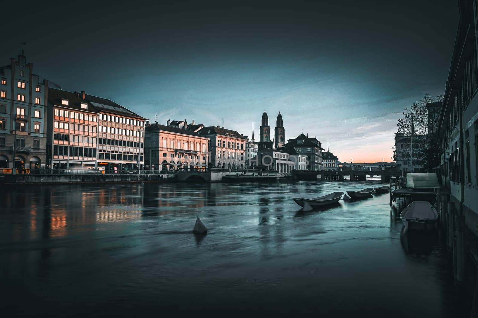 View of the River Limmat with boats on the water and the old town of Zurich. High quality photo