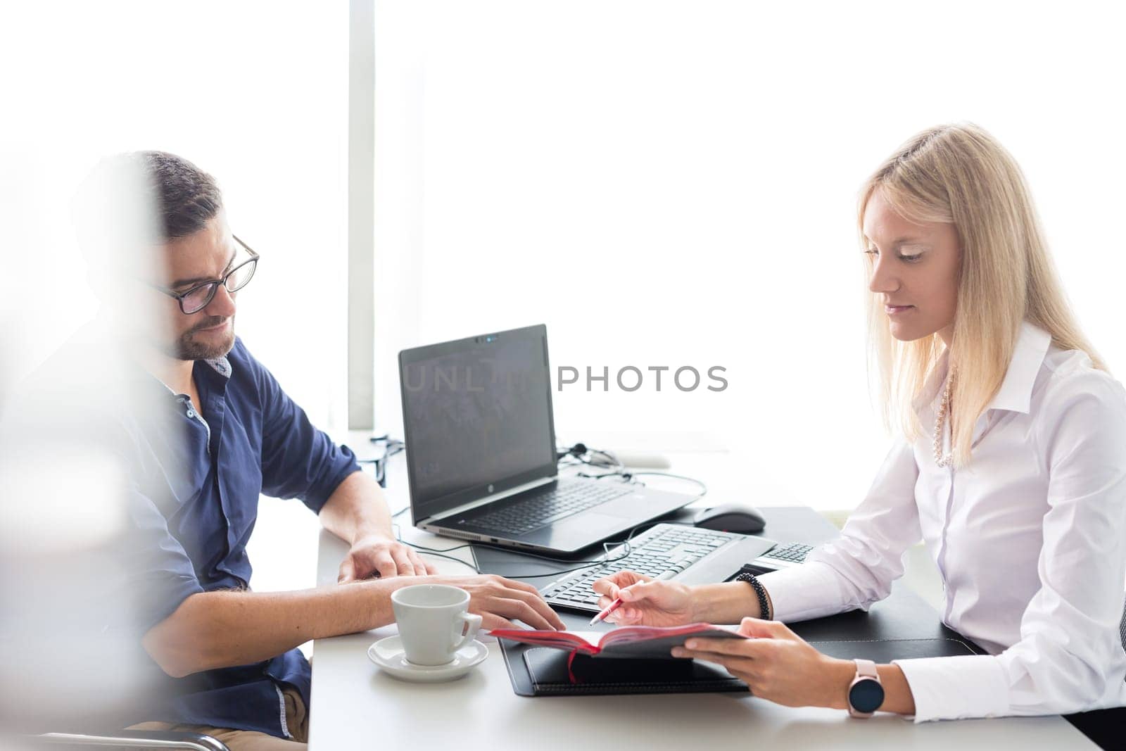 Business meeting. Client consulting. Confident business woman, real estate agent, financial advisor explaining details of project or financial product to client in office. by kasto