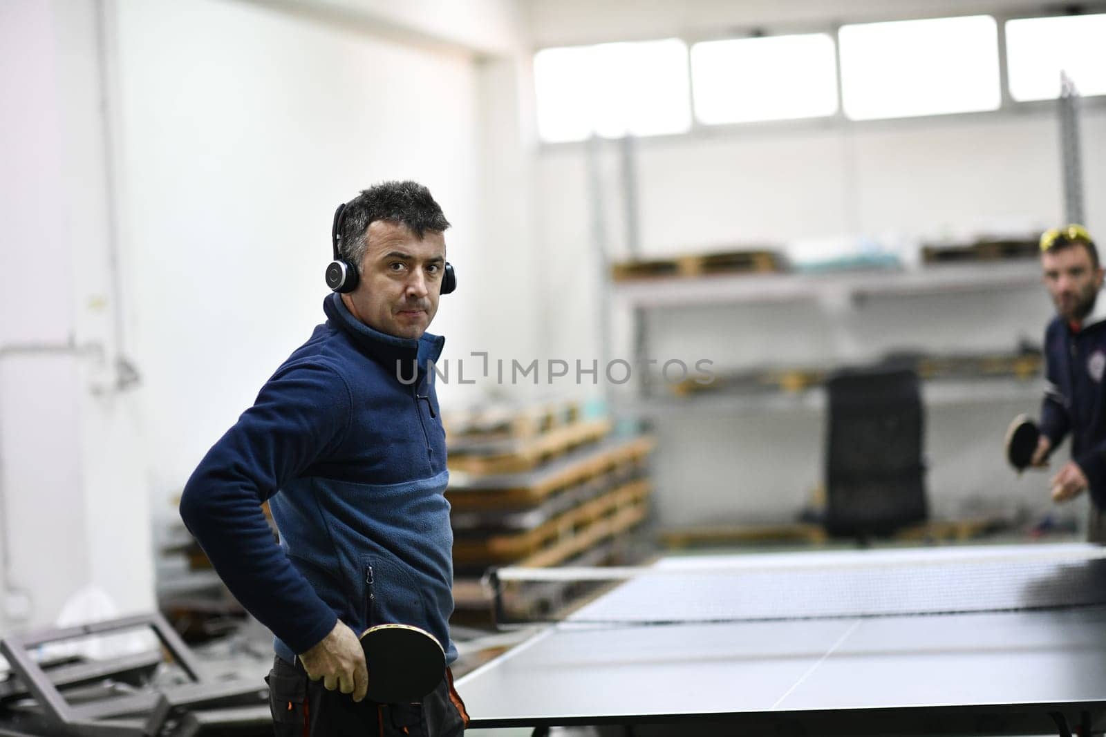 industry workers table tennis game and relaxing in their free time by dotshock