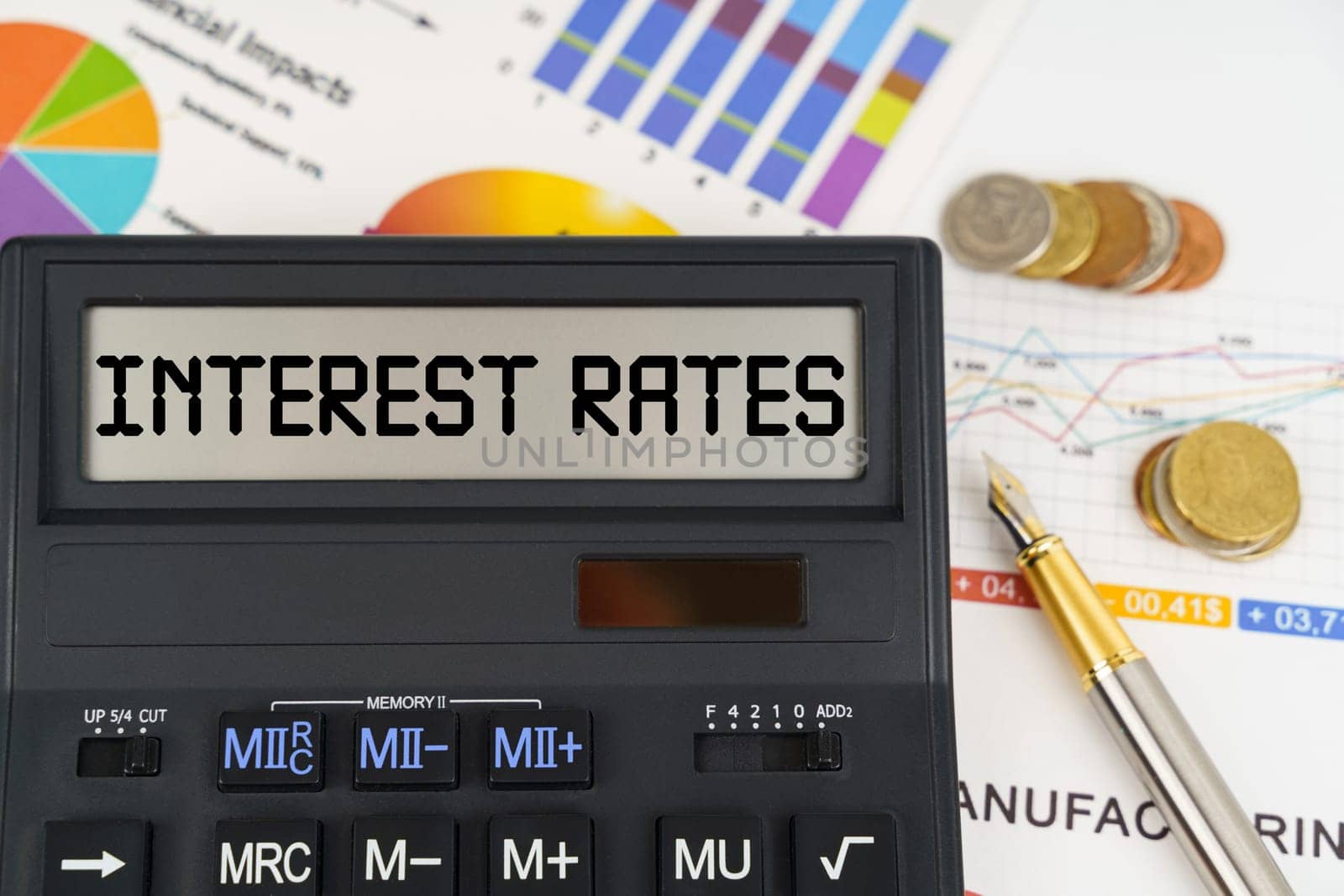 Business concept. On the table are financial reports, coins and a calculator with the inscription - Interest rates