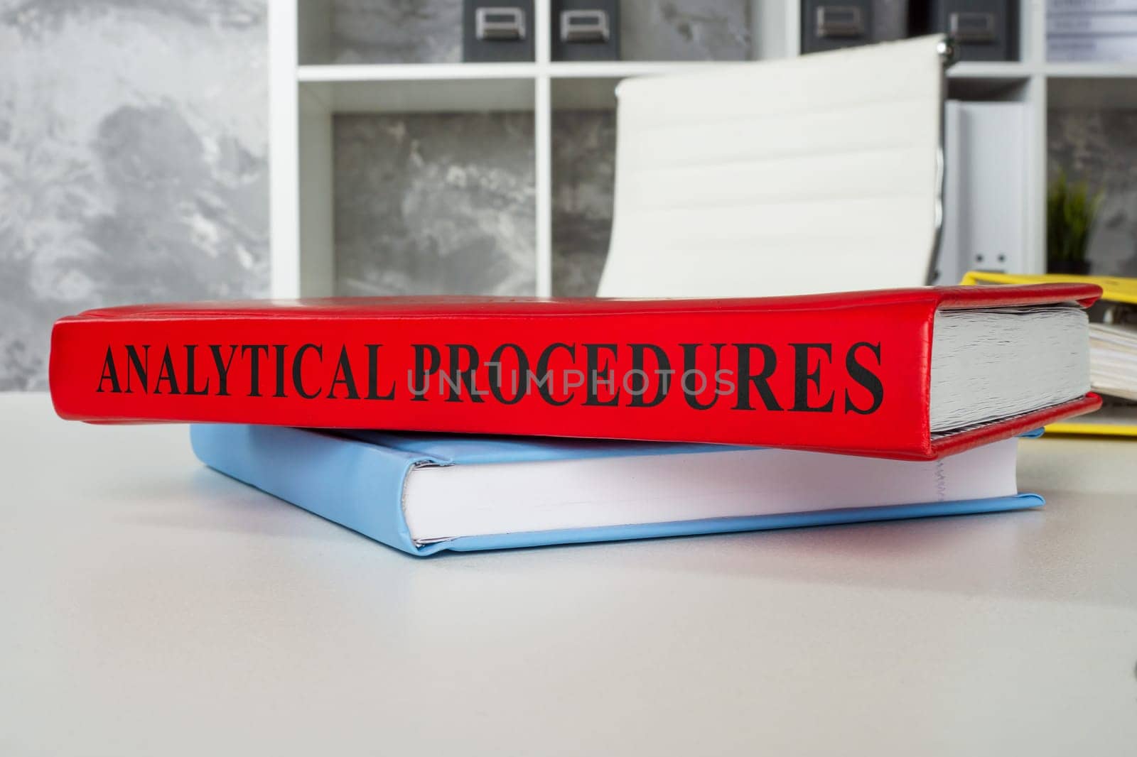 The book analytical procedures lies on the office table. by designer491