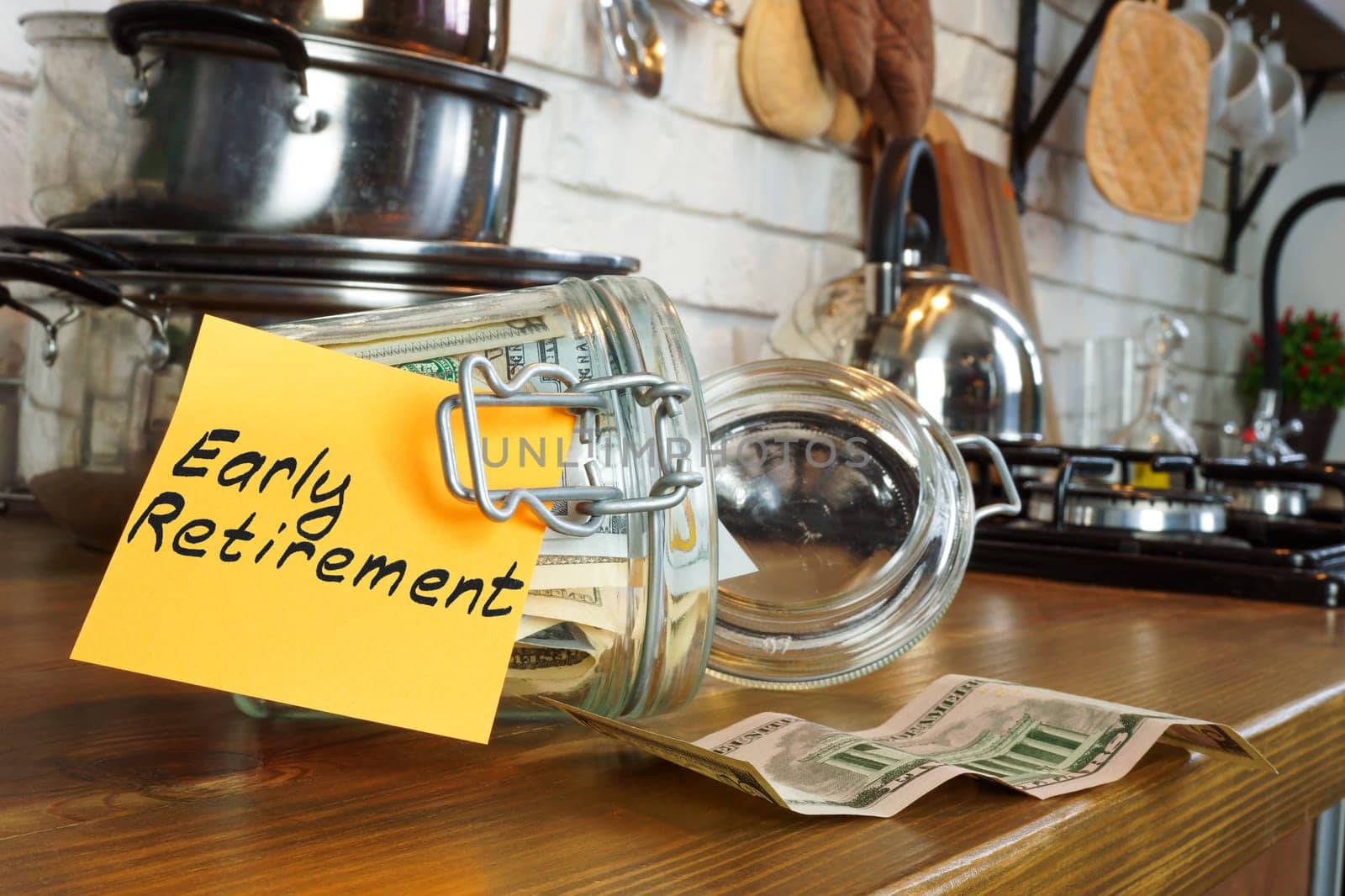 Early retirement concept. Glass jar with money on the home table. by designer491