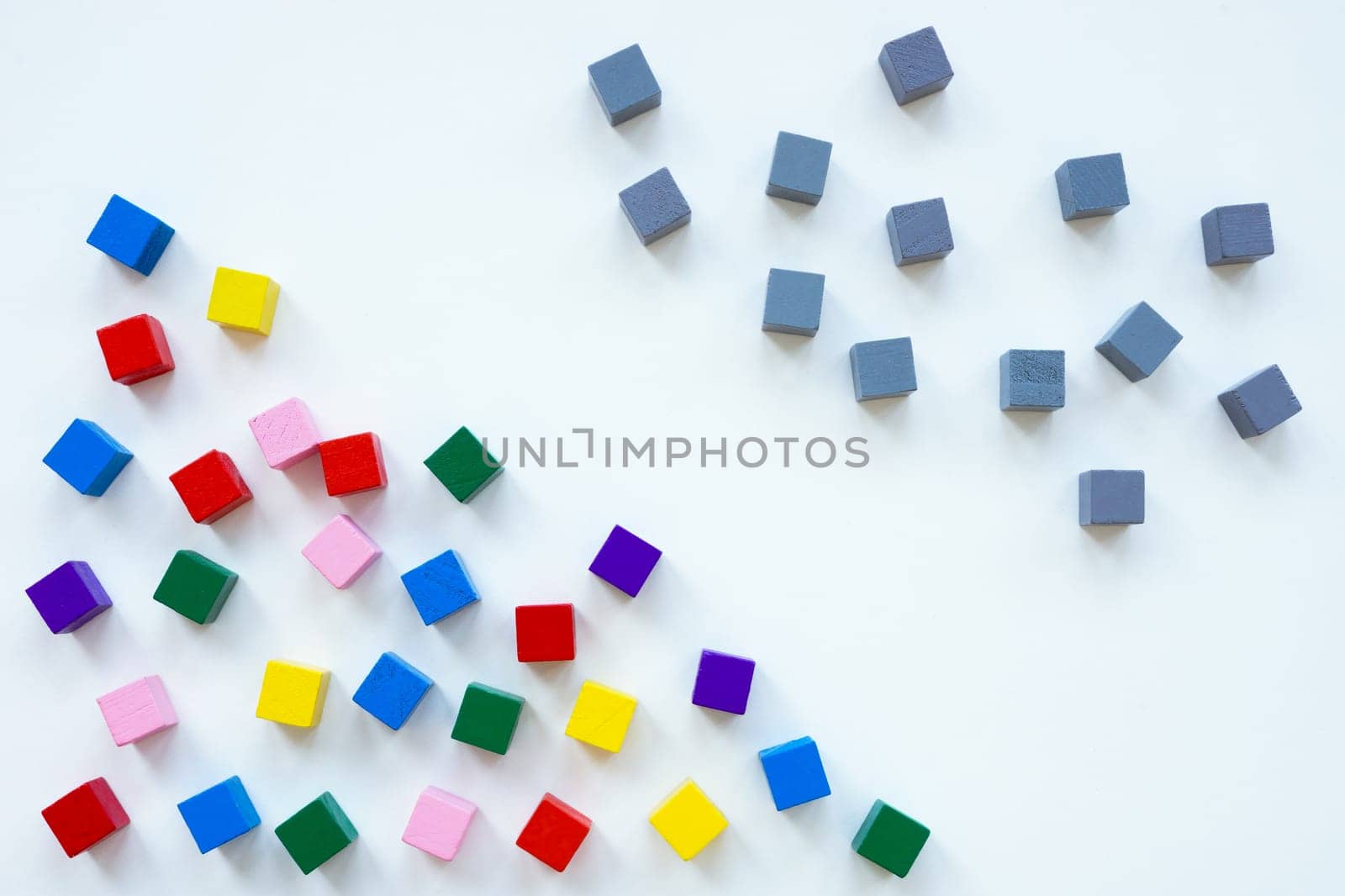 Gray cubes and multicolored ones as a symbol of diversity.