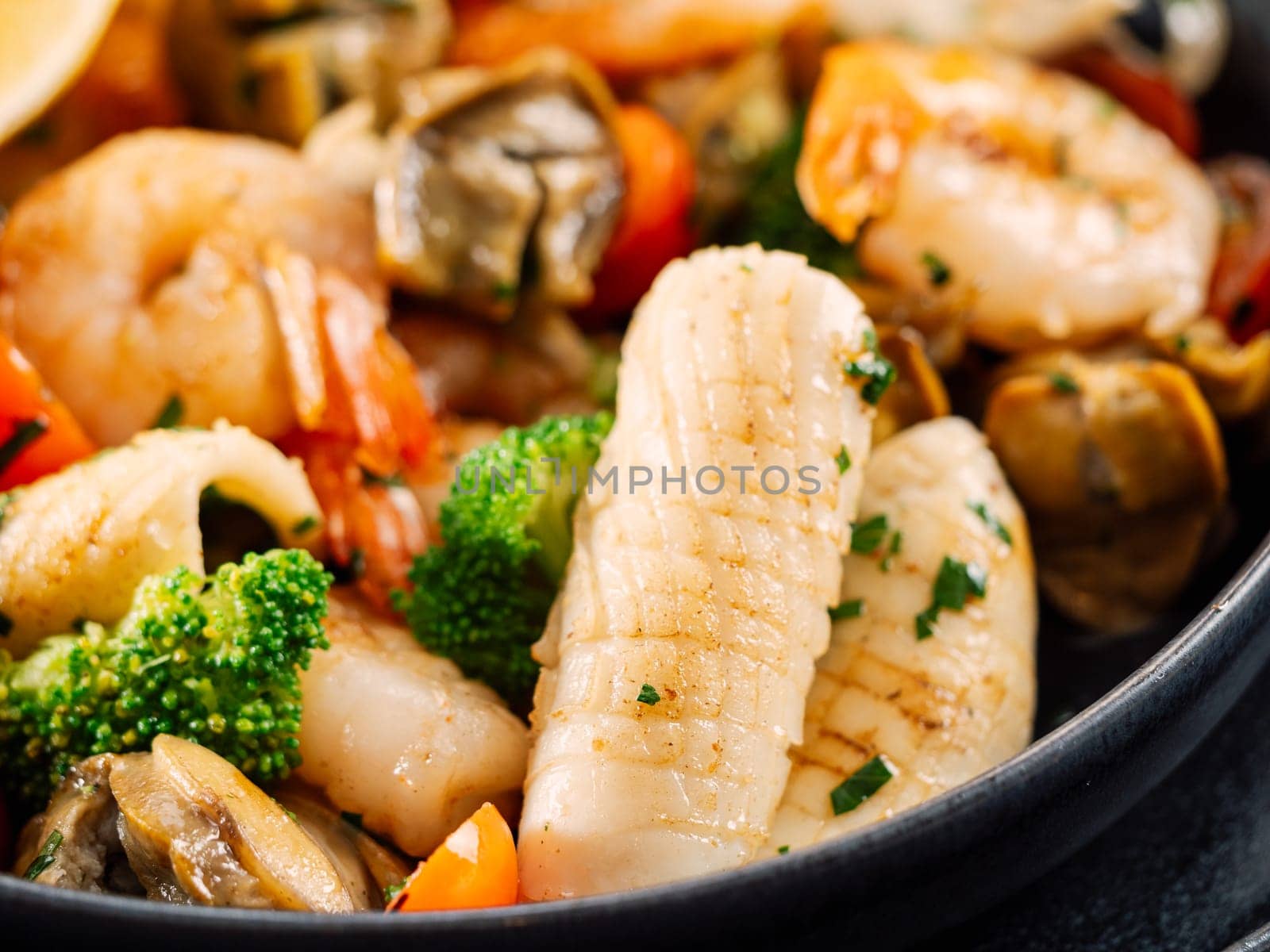 Salad with Mixed Seafood on dark plate by fascinadora
