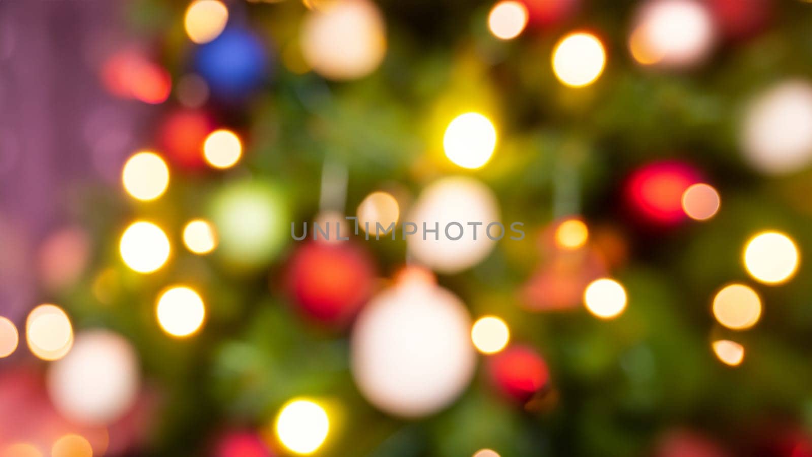 Defocused Christmas tree with colorful bokeh lights. Abstract background.