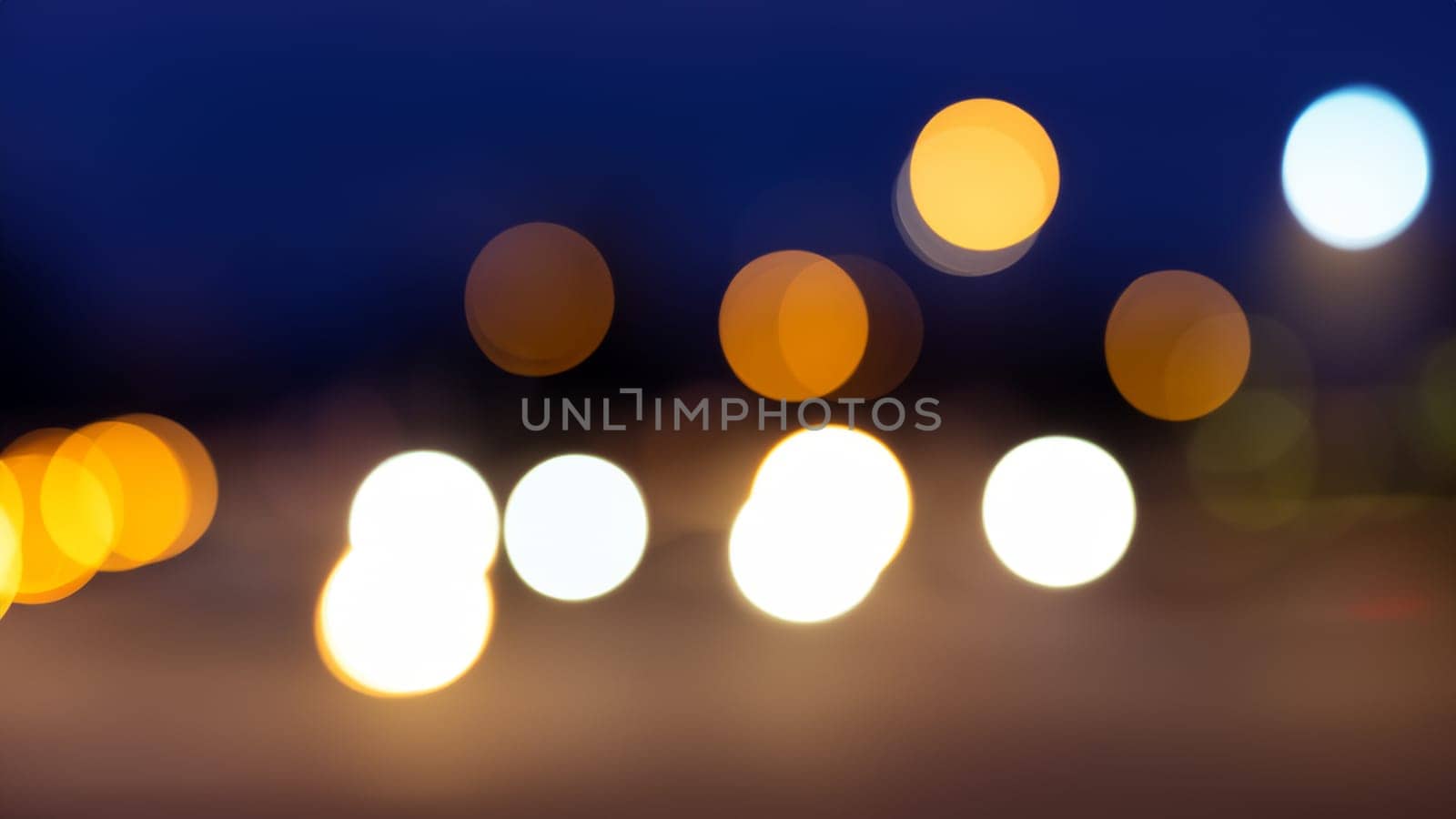 Abstract bokeh of car light on road at night streetlights background. by DesignMarjolein