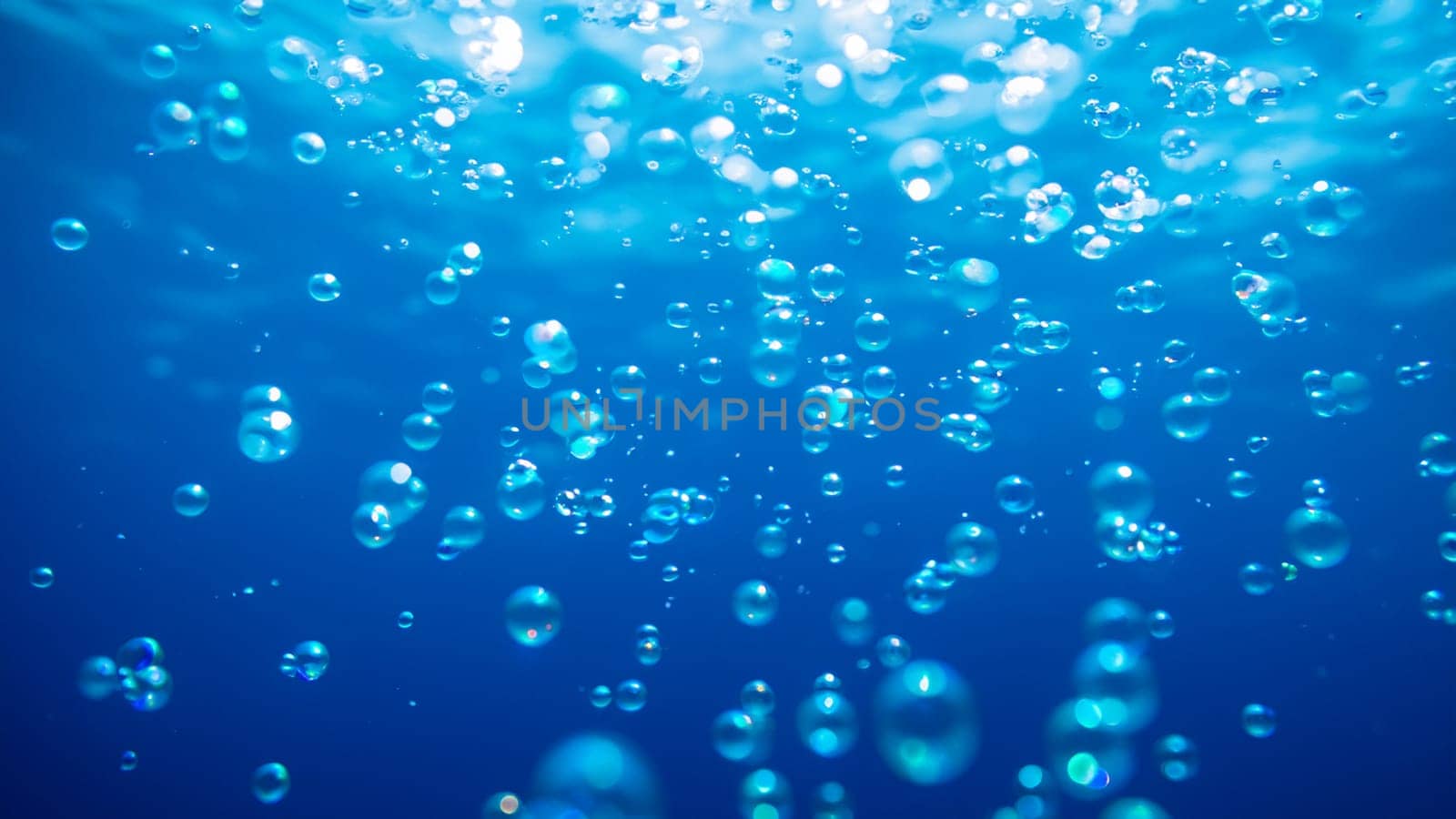 Bubbles in blue water. Underwater background by DesignMarjolein