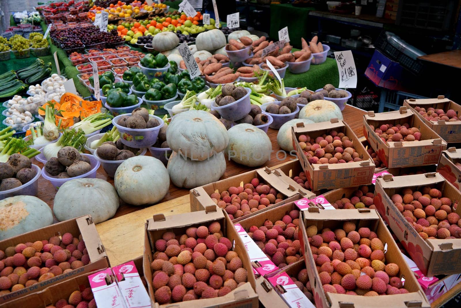 London, United Kingdom - February 04, 2019: Typical food market at Lewisham, Litchi, pumpkins and other vegetable / fruit displayed on street stall. It is usually sold in bowls, with same price tag by Ivanko