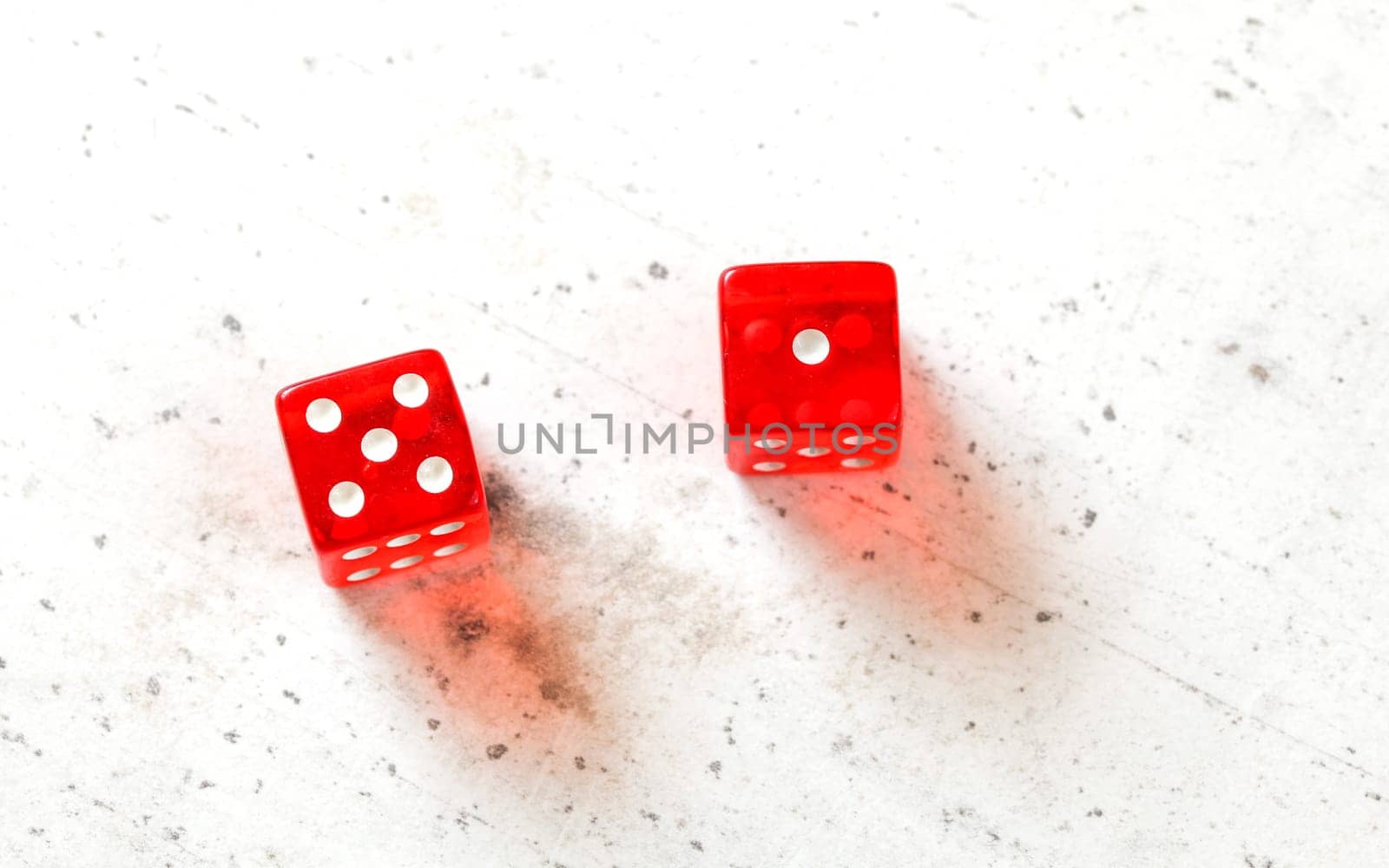 Two red craps dices showing Easy Six / Jimmie Hicks (number 5 and 1) overhead shot on white board by Ivanko