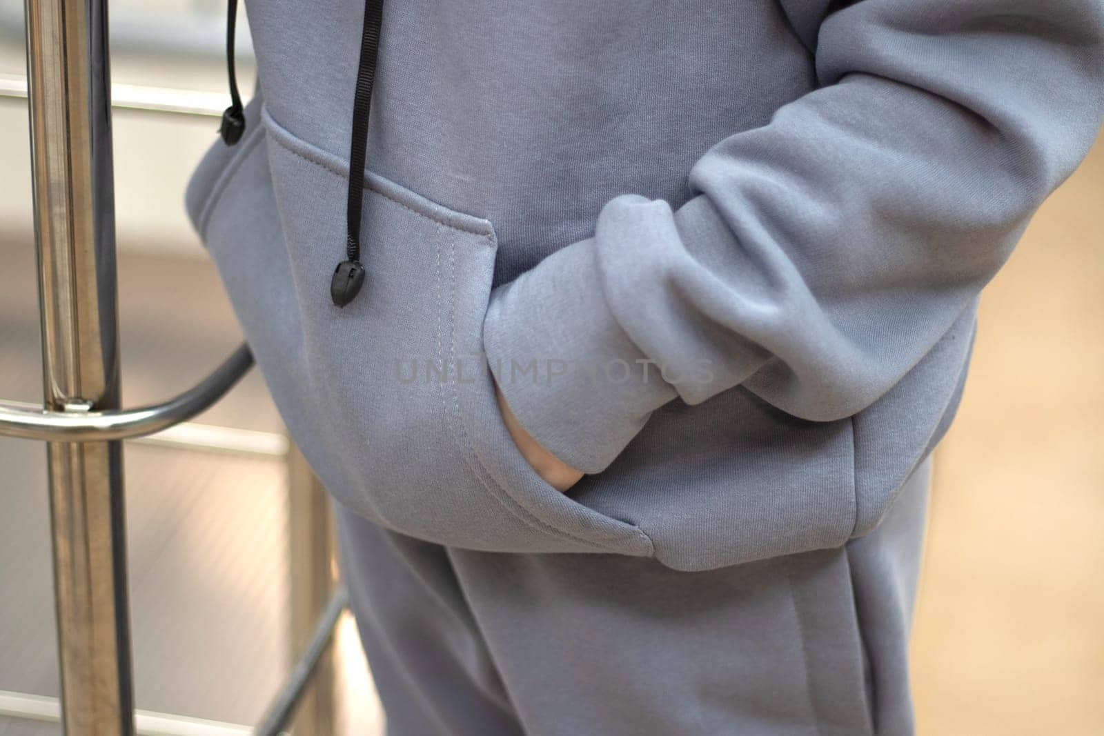 young woman in gray hoodie hands in the pockets close up mockup copyspace. by Suietska