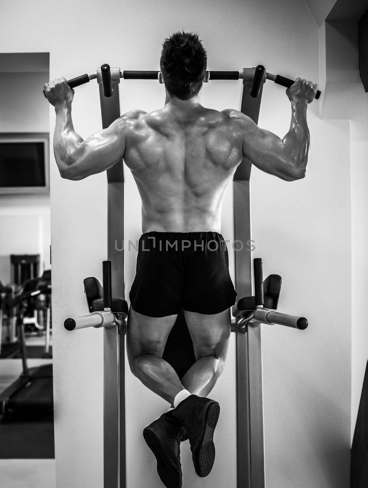 bodybuilder pulling up on a bar in a gym by GekaSkr