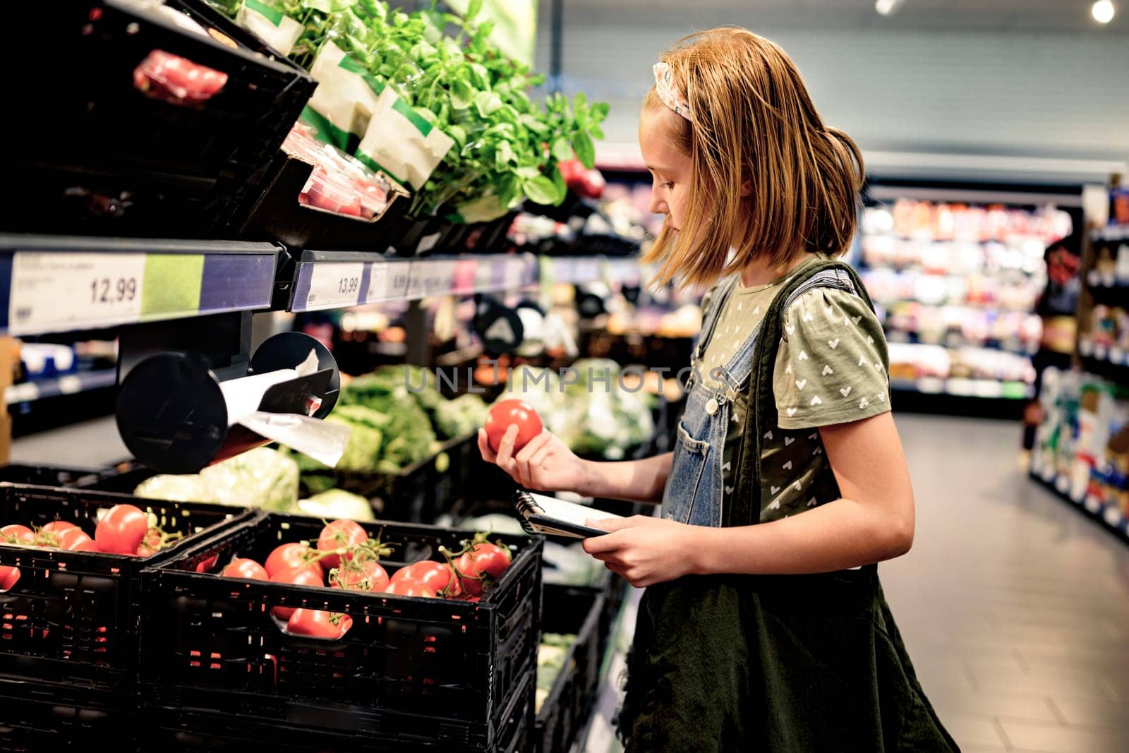 Pretty girl child shopping in supermarket by GekaSkr