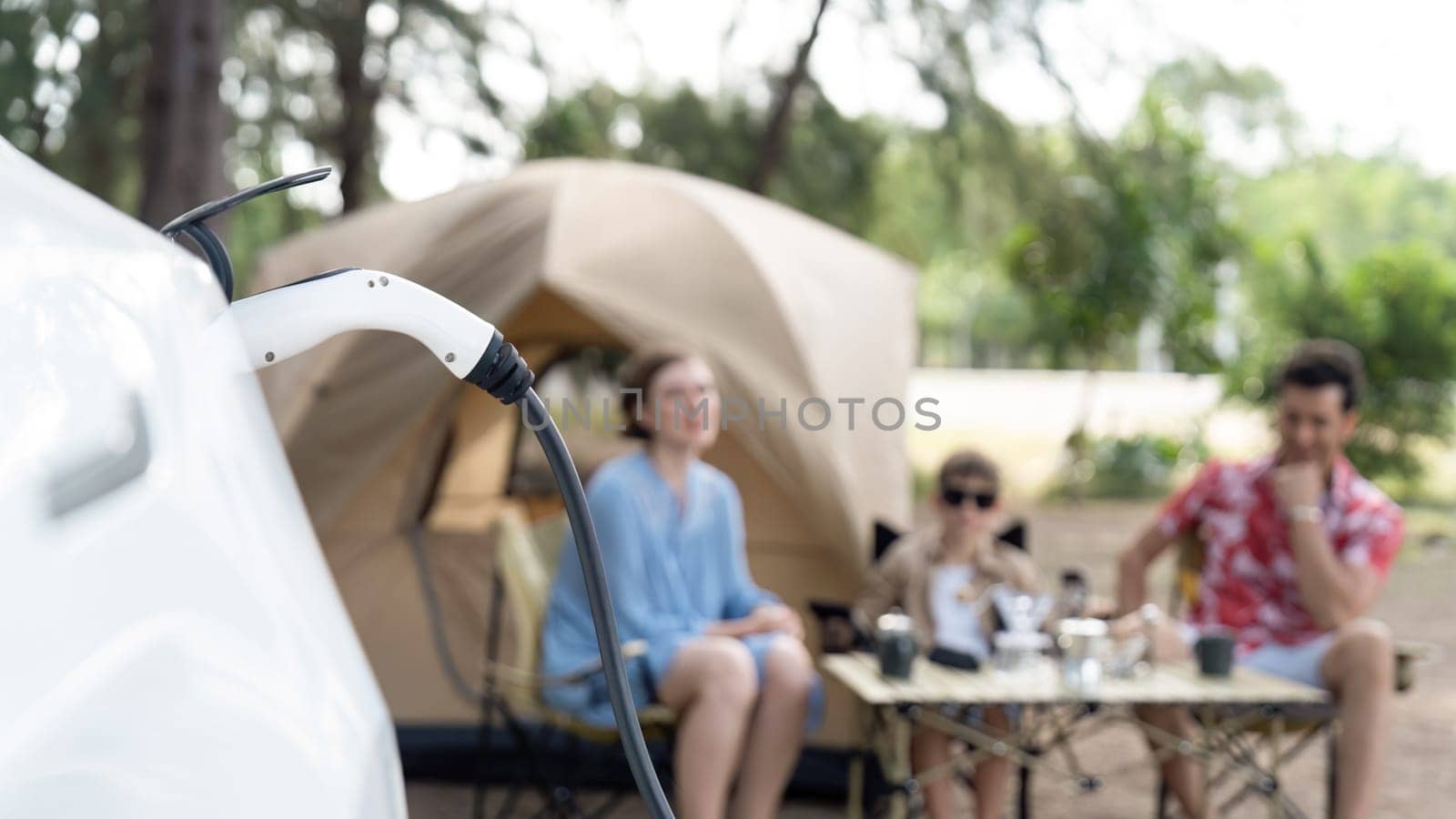 Lovely sit on trunk, charging EV car with EV charging station. Perpetual by biancoblue